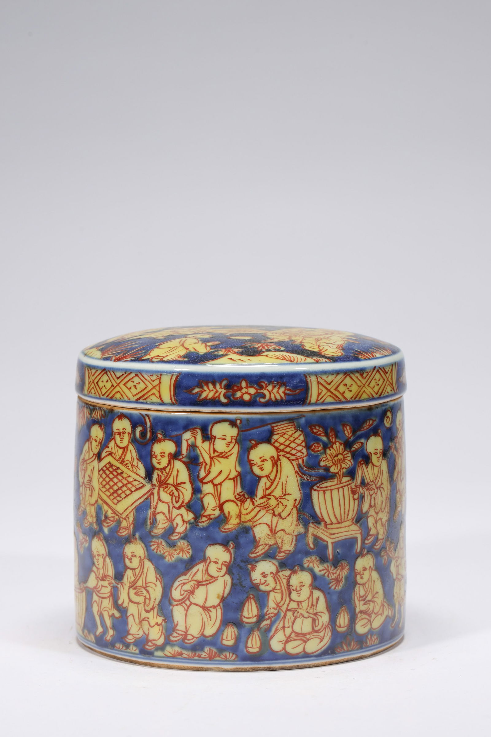 BLUE GROUND YELLOW GLAZE CHILDREN JAR AND COVER: Blue ground yellow glaze children jar and cover.Dimensions: Height: 12.5 cm, Diameter: 13 cm.