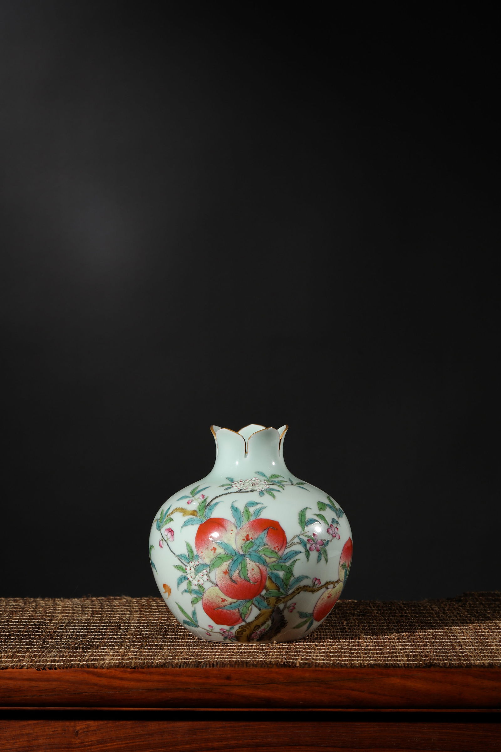 CELADON GROUND FAMILLE ROSE PEACH POMEGRANATE-FORM VASE: Celadon ground famille rose peach pomegranate-form vase.Dimensions: Height: 15.7 cm, Width: 14.5 cm.