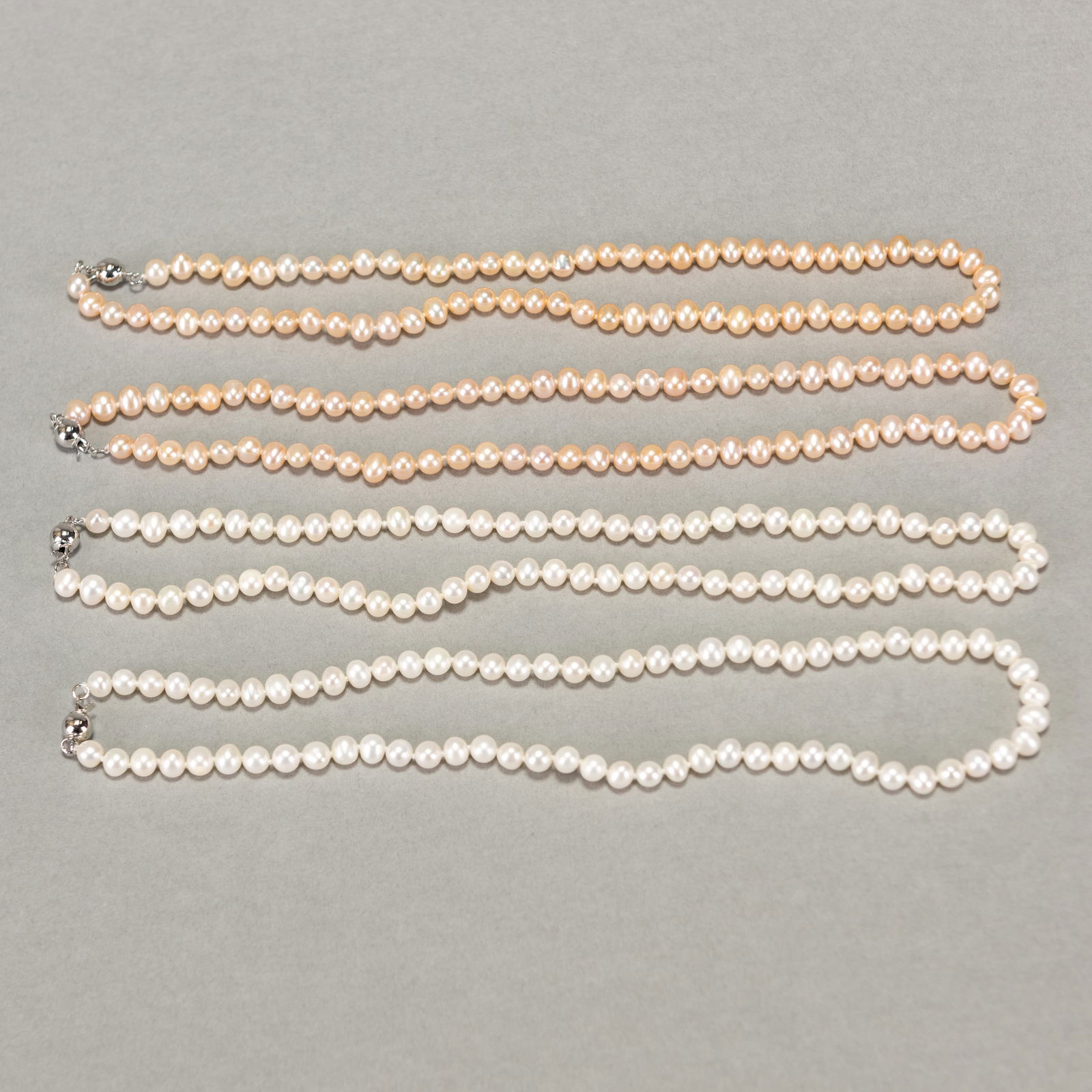 FOUR STRANDS OF WHITE, PINK AND PEACH PEARL NECKLACES (1 of 3)