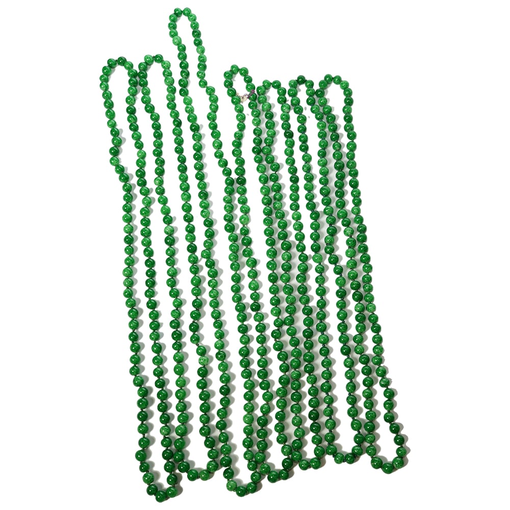 GROUP OF 7 STRANDS OF GREEN PEKING GLASS NECKLACES: (Lot of 7) seven strands of green Peking glass necklaces, imitating jadeite. Longest: 19.69"l (50 cm) Provenance: Property from the Estate of Gloria Hebert, Santa Barbara, California.