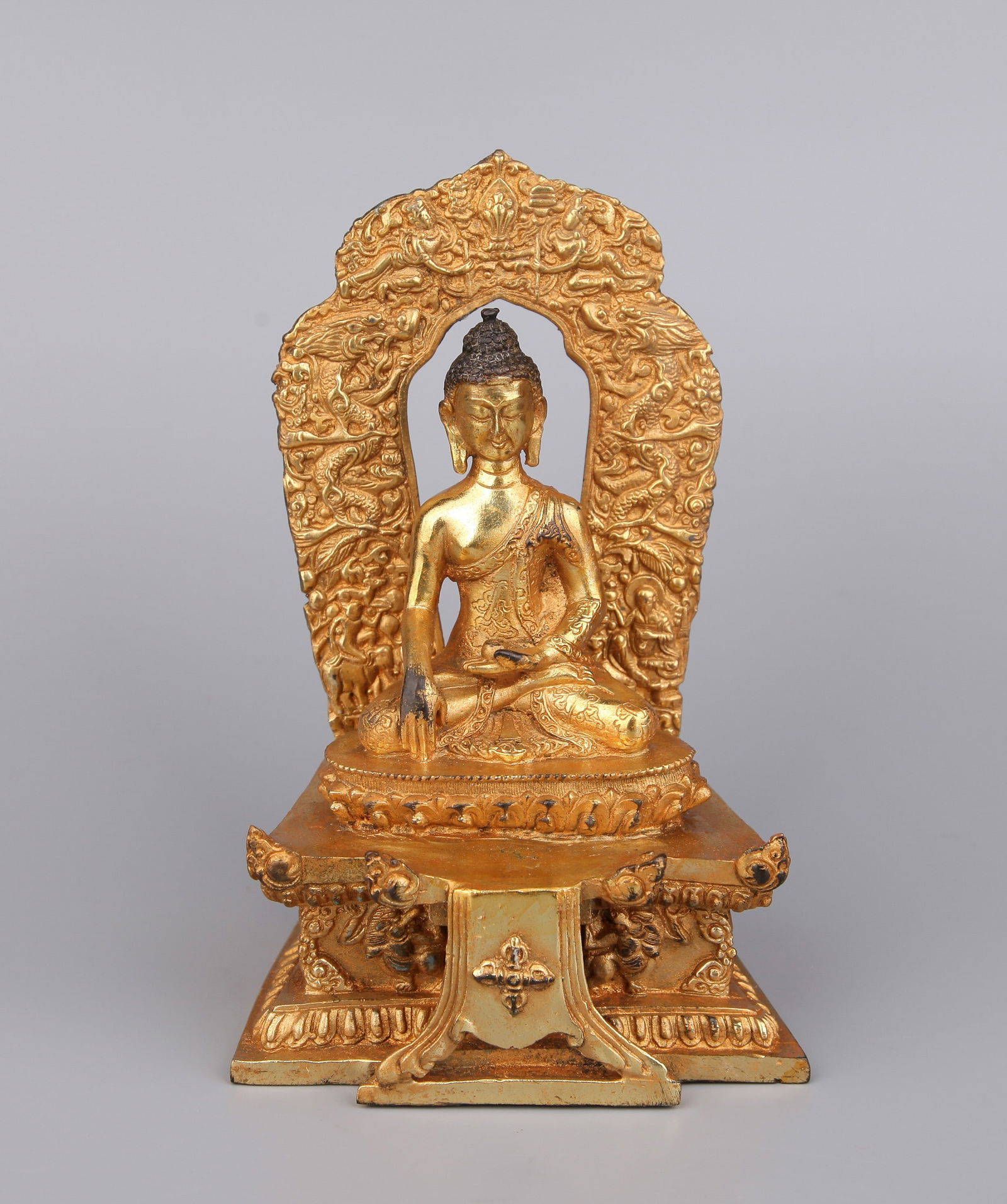 A GILT-BRONZE FIGURE OF SHAKYAMUNI BUDDHA: A gilt-bronze figure of Shakyamuni Buddha.Height 17 cm.