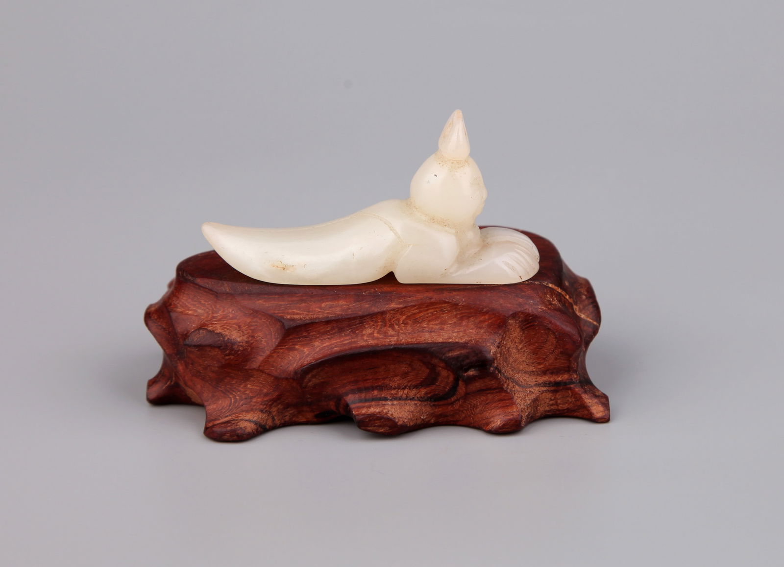 A JADE FIGURE: A Hetian jade figure.Length 6.8 cm.