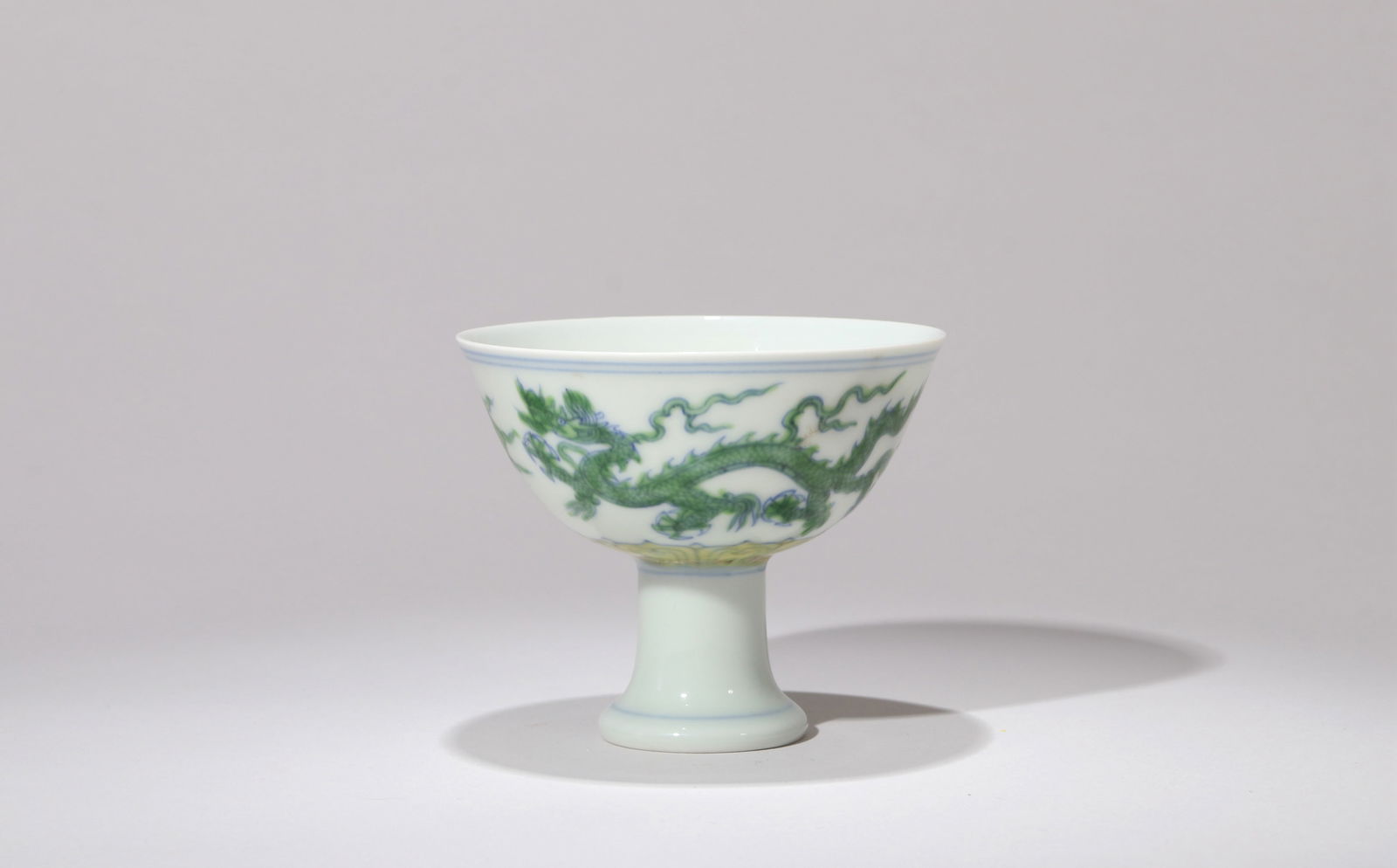 A GREEN-ENAMELLED STEM CUP: A green-enamelled stem cup decorated with dragon design.Diameter 9.5 cm, Height 8 cm.