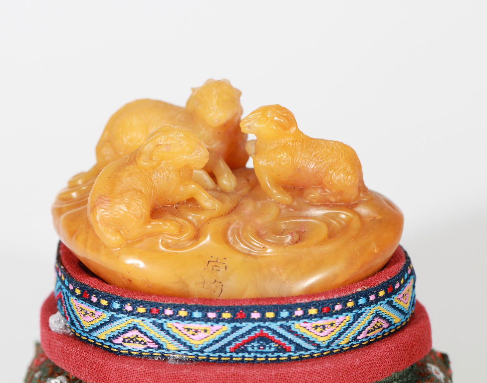 A TIANHUANG STONE CARVING: A Tianhuang stone carving of 'Three Rams'. Length 6.5 cm, Weight 104 g. Note: By repute, carved by Shang Jun.