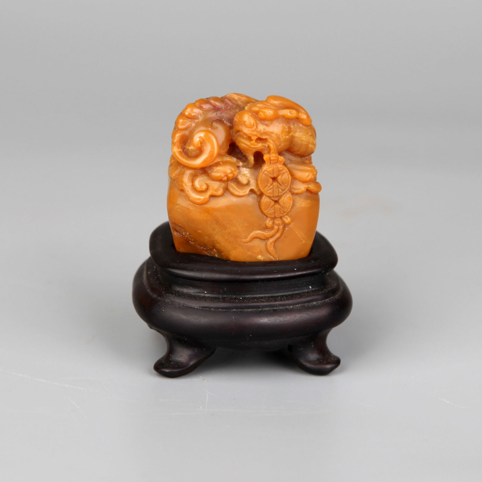 A SEAL STONE: A seal stone with mythical beast knob.Height 5 cm (including stand).