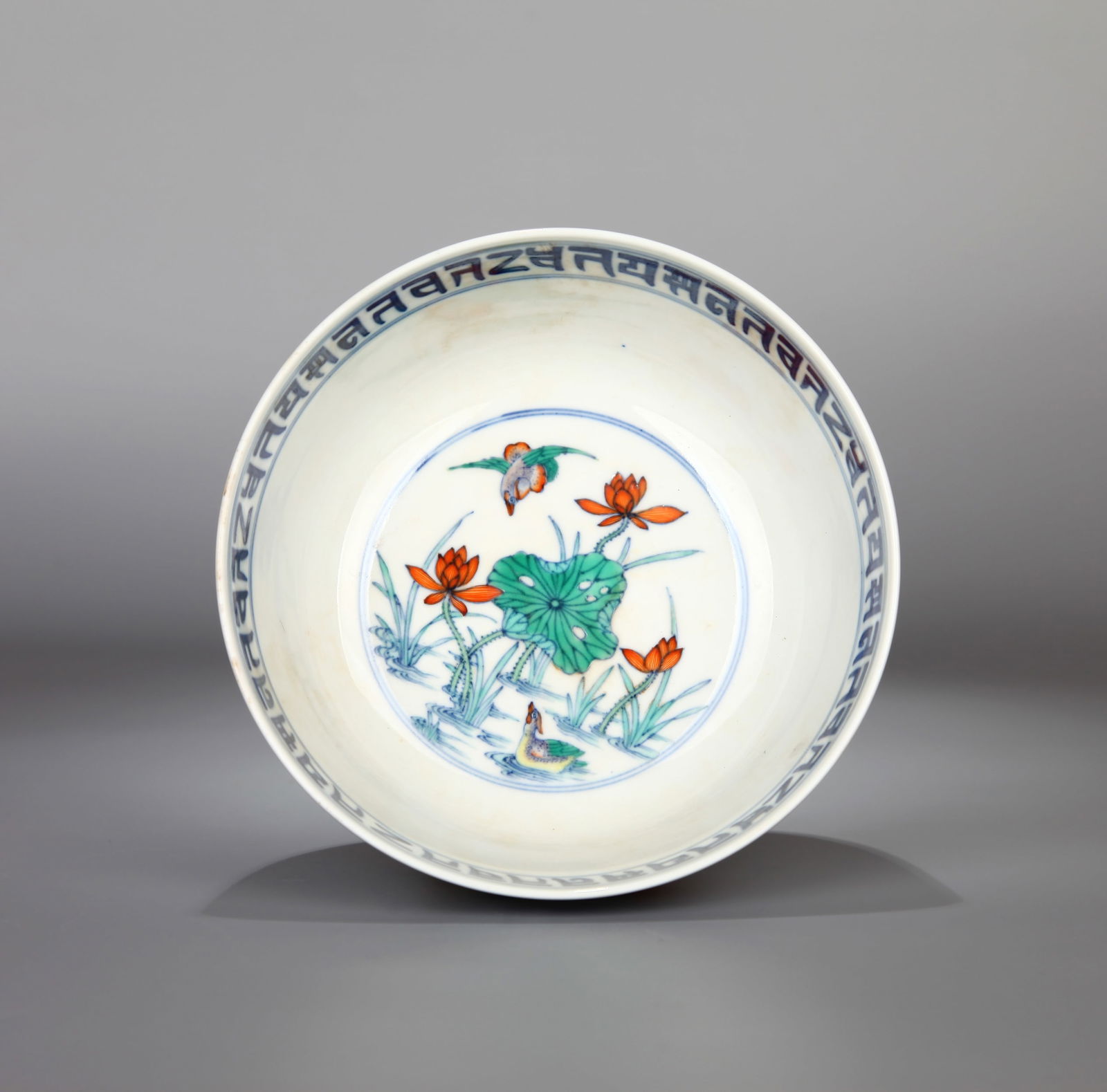 A DOUCAI BOWL: A Doucai bowl decorated with lotus pond and mandarin ducks.Height 7.5 cm, Diameter 16.6 cm.