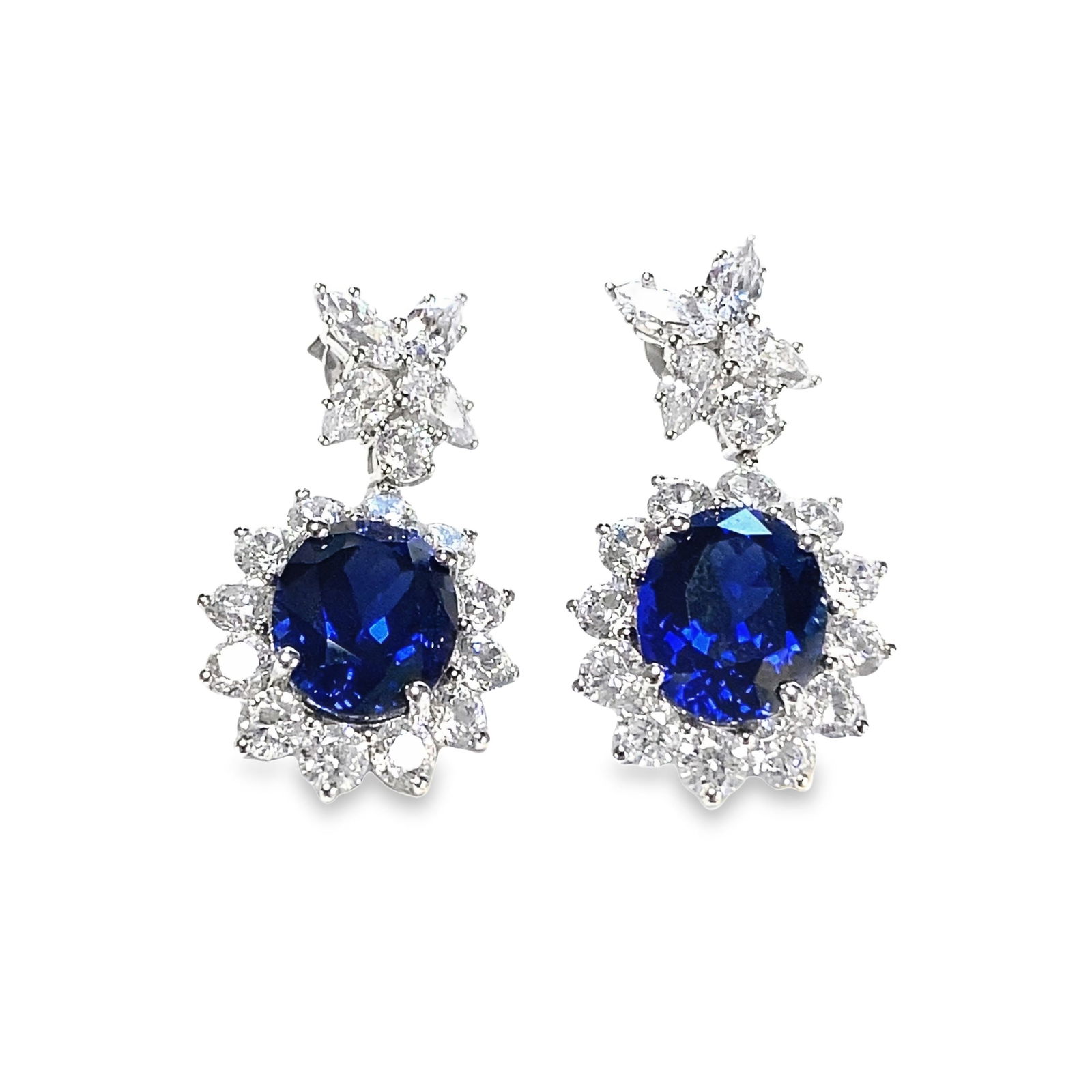 A PAIR OF LAB-GROWN SAPPHIRE AND DIAMOND EARRINGS: A pair of lab-grown sapphire and diamond earrings over sterling silver.Main stone: H 1.1 x W 0.9 cm; Weight 9.63 ct (x2).