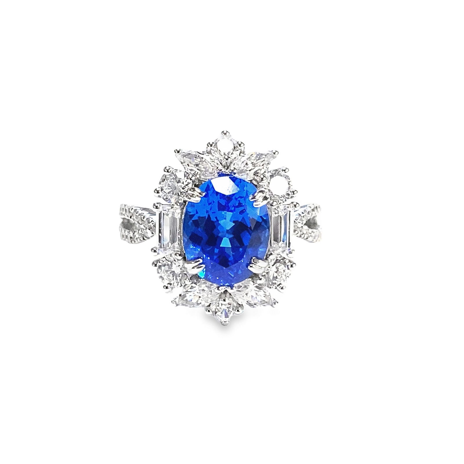 A LAB-GROWN SAPPHIRE AND DIAMOND RING OVER STERLING SILVER: A lab-grown sapphire and diamond ring over sterling silver, centering an oval-shaped lab-grown sapphire, framed by lab-grown diamonds, approximately 3.41 carats.Size 6.25; Weight 3.8 dwt.