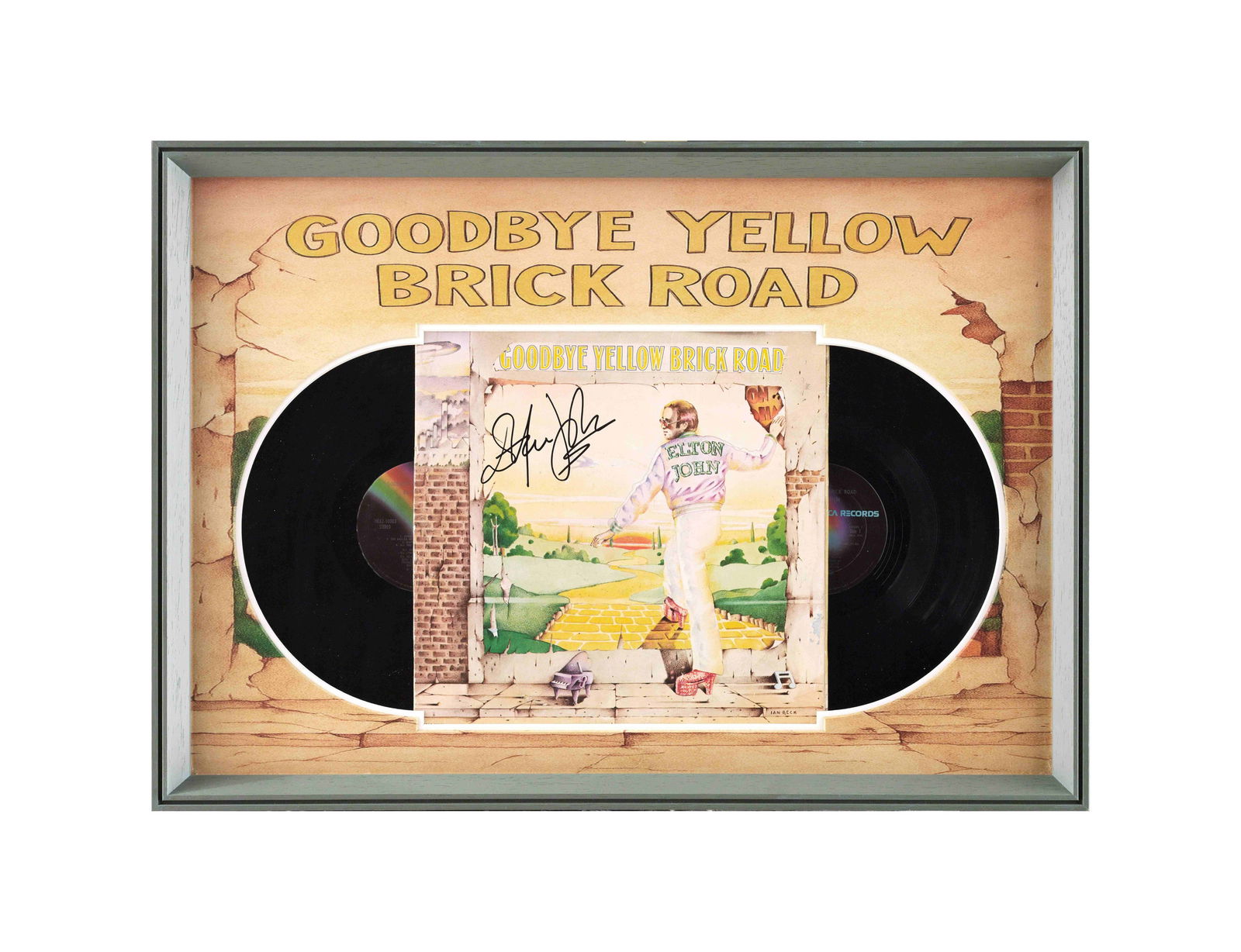ELTON JOHN VINYL RECORD 'GOODBYE YELLOW BRICK ROAD' BEARING SIGNATURE: A double-album 'Goodbye Yellow Brick Road' displayed within a custom presentation frame. The front cover bears a signature in black marker reading 'Elton John', placed prominently across the sky secti