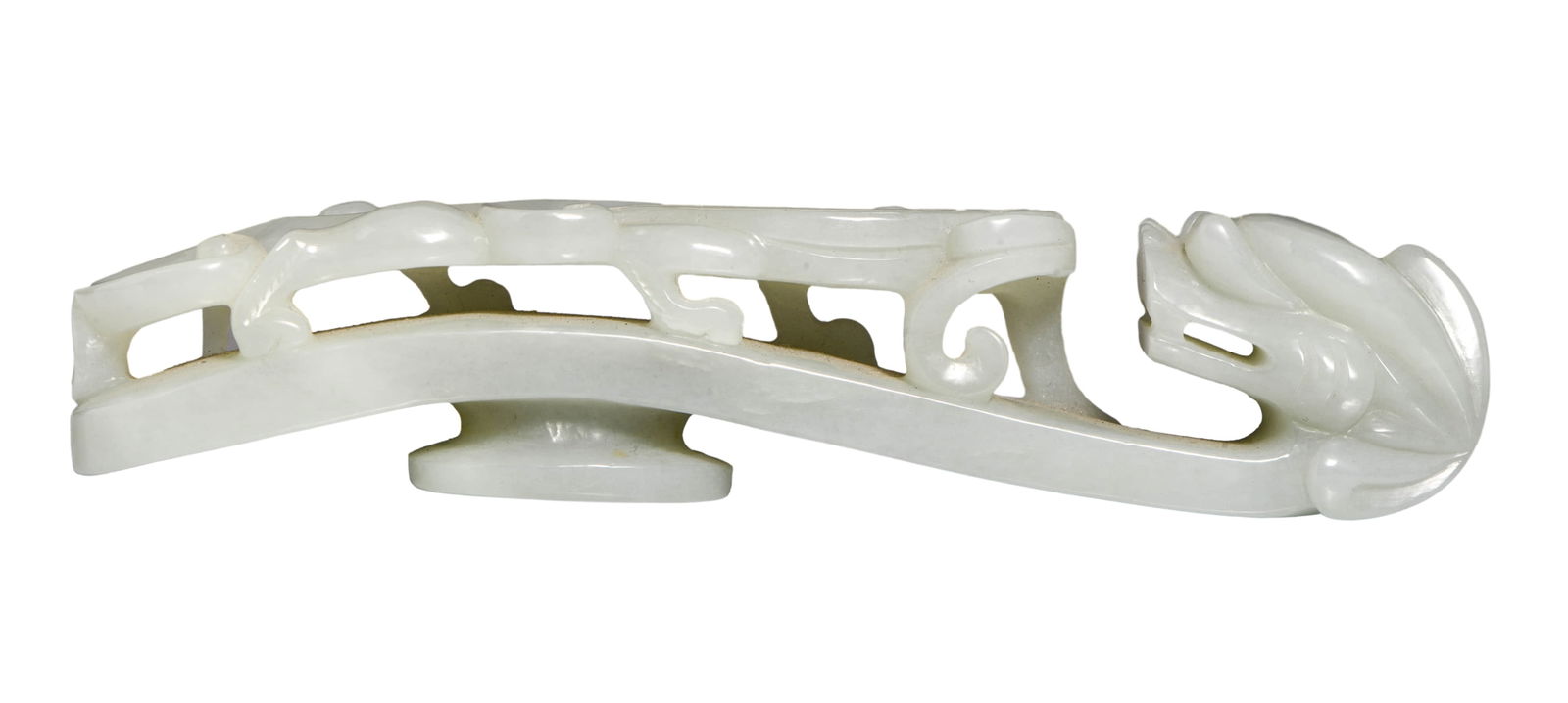 A WHITE JADE 'DRAGON INSTRUCTING OFFSPRING' BELT HOOK: A finely carved white jade belt hook featuring a dragon and offspring motif.Dimensions: Width: 16 cm (6.30 in.), Height: 3.5 cm (1.38 in.). All measurements are approximate.
