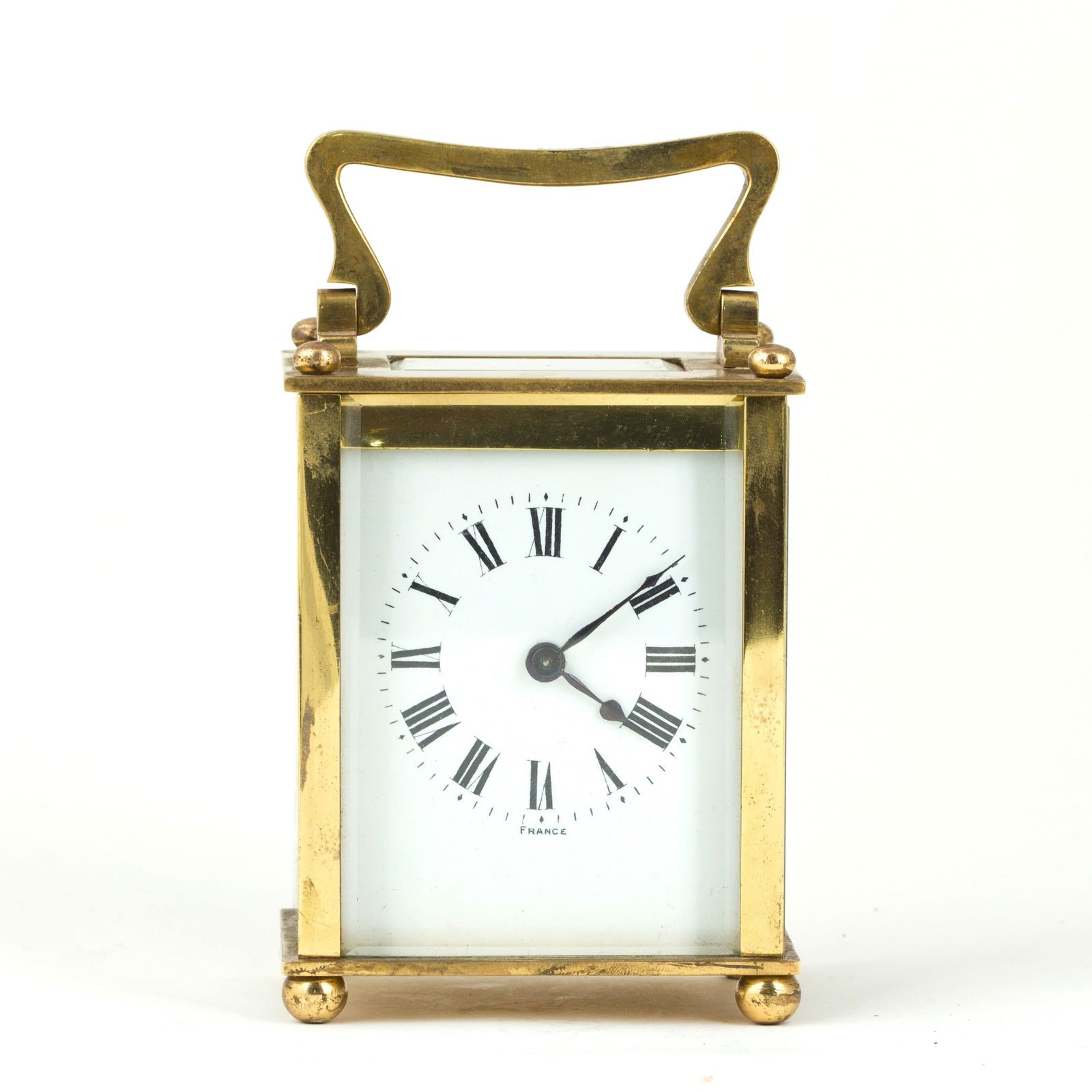 RECTANGULAR MECHANICAL ANTIQUE CLOCK: Rectangular mechanical antique clock in classical style with a carrying handle.Dimensions: 5"h x 5.25"w x 3"l (12.70 x 13.34 x 7.62 cm)