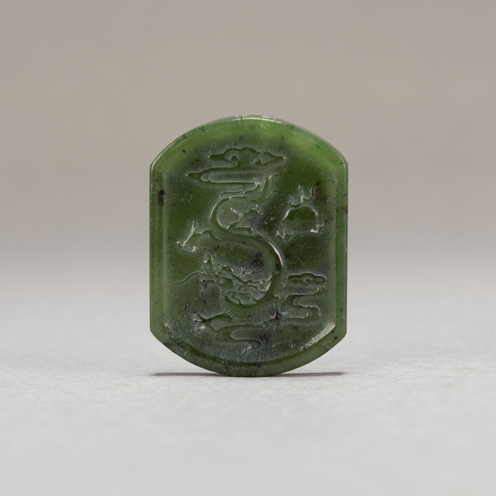 CHINESE SPINACH JADE 'DRAGON' PLAQUE: Chinese spinach jade 'dragon' plaque.Dimensions: 2.17"h x 1.57"w x 0.16"l (5.5 x 4 x 0.4 cm)