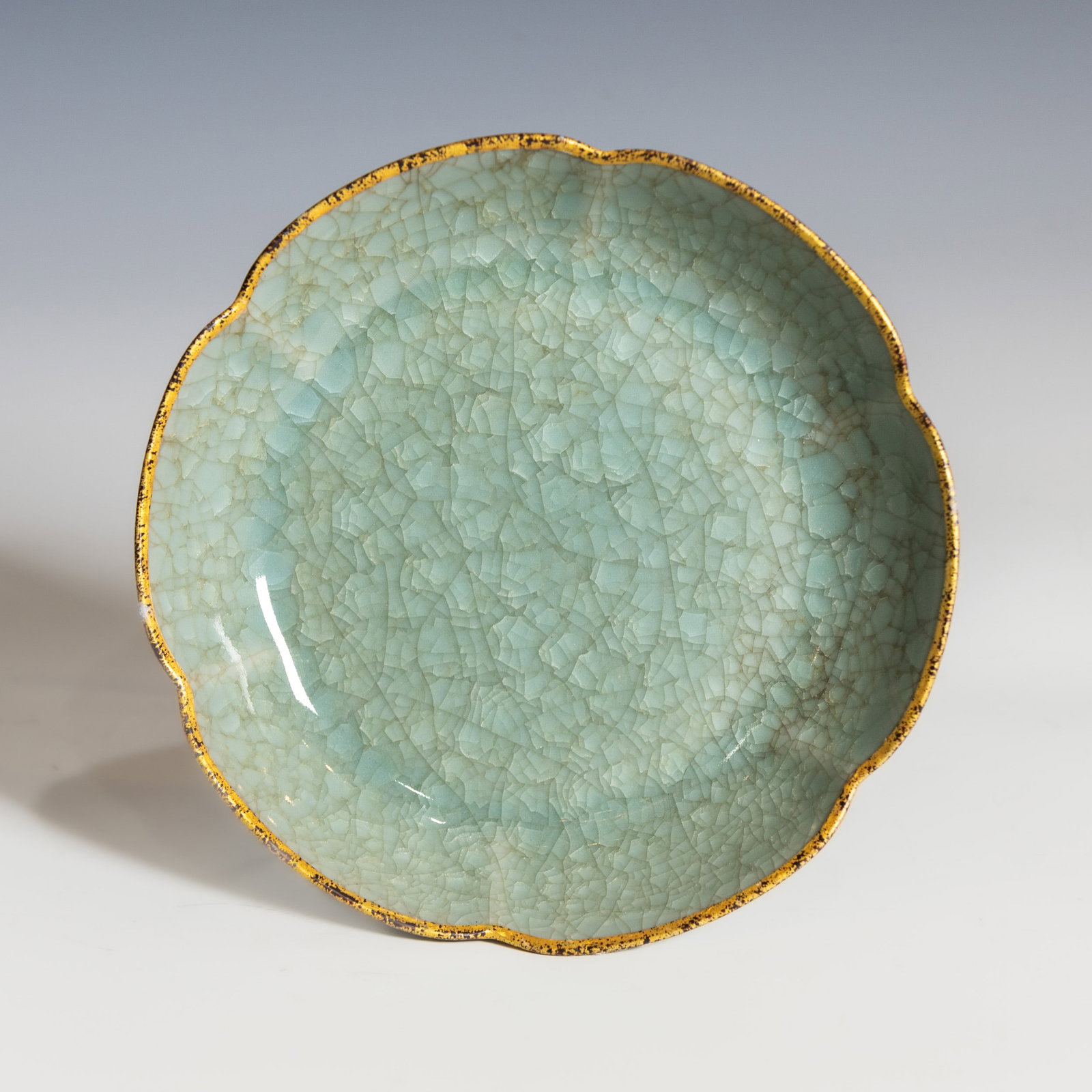 A CHINESE CELADON DISH: A famille rose 'dragon' covered tea bowl. Dimensions: Diameter 4" Height 3.25"
