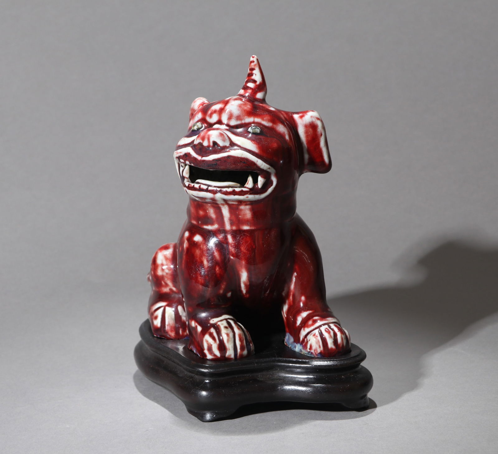 A FLAMBE-GLAZED MYTHICAL BEAST: A flambe-glazed ornament of a mythical beast.Height 15.5 cm.