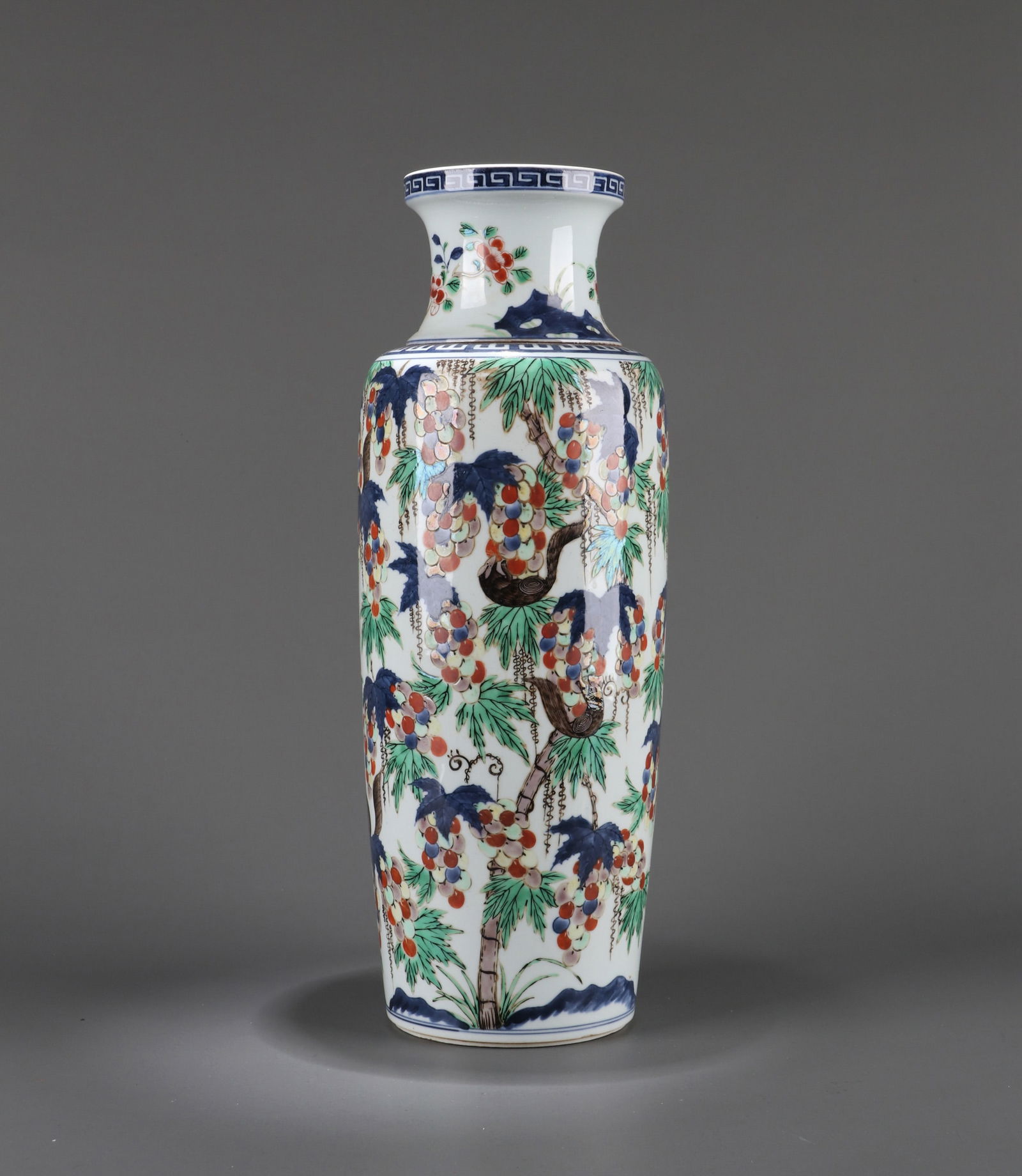 A BLUE AND WHITE AND WUCAI VASE: A blue and white and Wucai cylindrical vase decorated with squirrel and grape design. Height 41 cm.