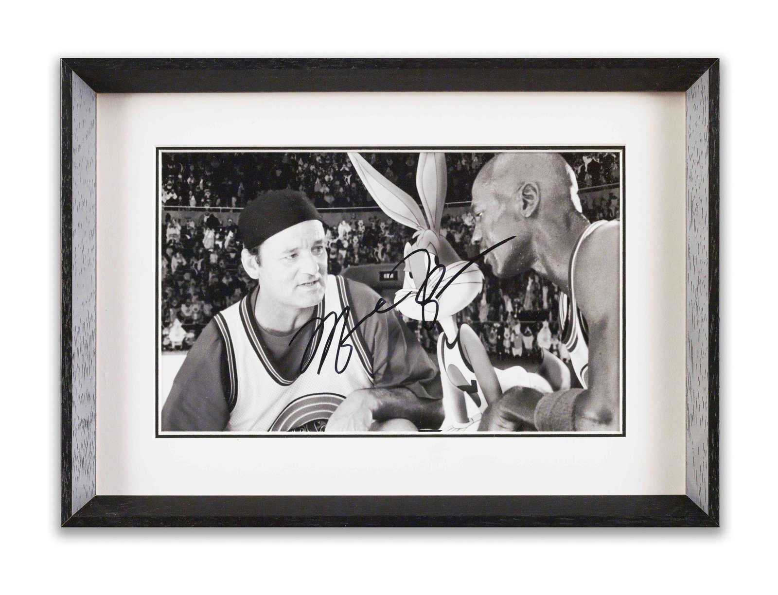PHOTOGRAPH BEARING SIGNATURE ATTRIBUTED TO MICHAEL JORDAN: The photograph captures a moment from "Space Jam", depicting Michael Jordan with Bill Murray and Bugs Bunny. Rendered in black and white, the image features a mark attributed to Michael Jordan across