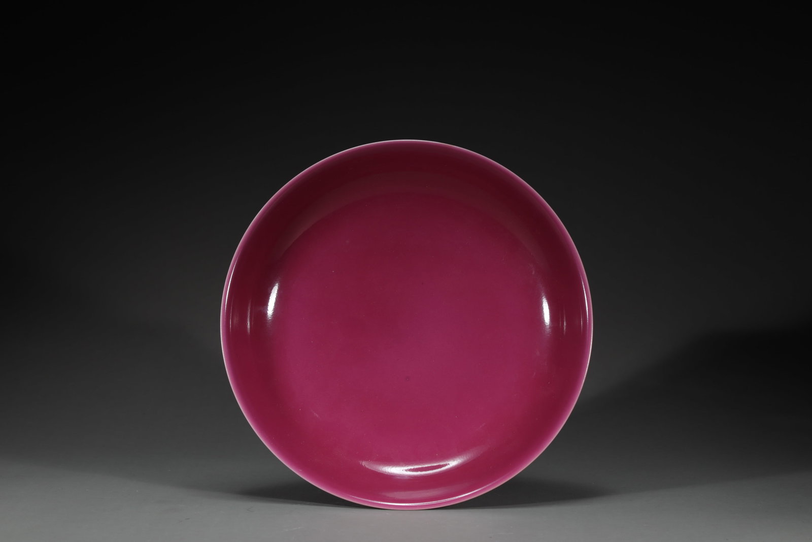 A ROUGE-RED-GLAZED DISH: A rouge-red-glazed dish.Dimensions: H: 4.3 cm, Diam: 20.5 cm.