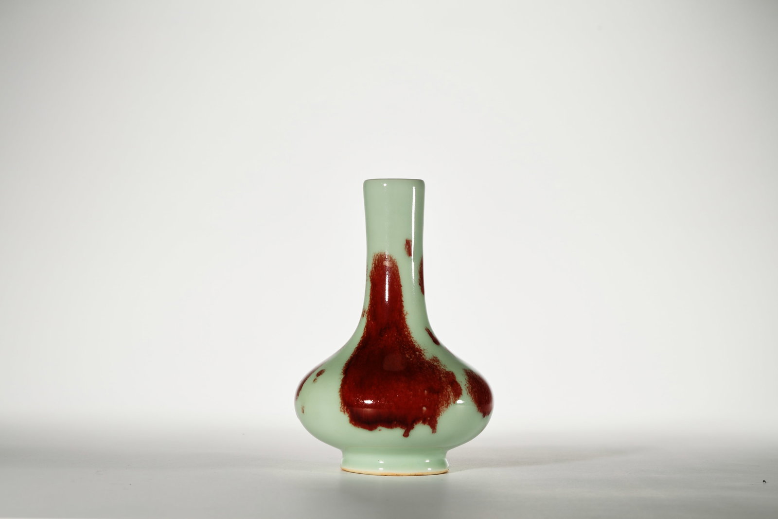 A CELADON-GROUND AND RED-GLAZED BOTTLE VASE (1 of 5)