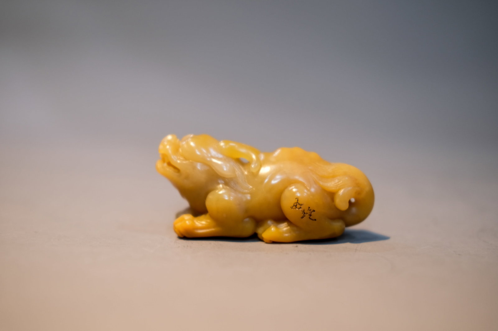 A YELLOWISH JADE 'QILIN' ORNAMENT (1 of 5)