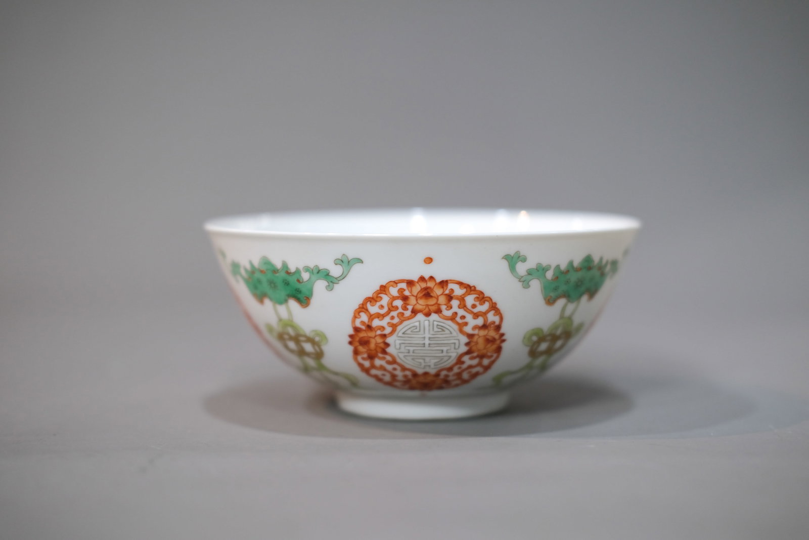 AN IRON-RED-GLAZED AND WUCAI 'BAT AND LONGEVITY' BOWL (1 of 3)