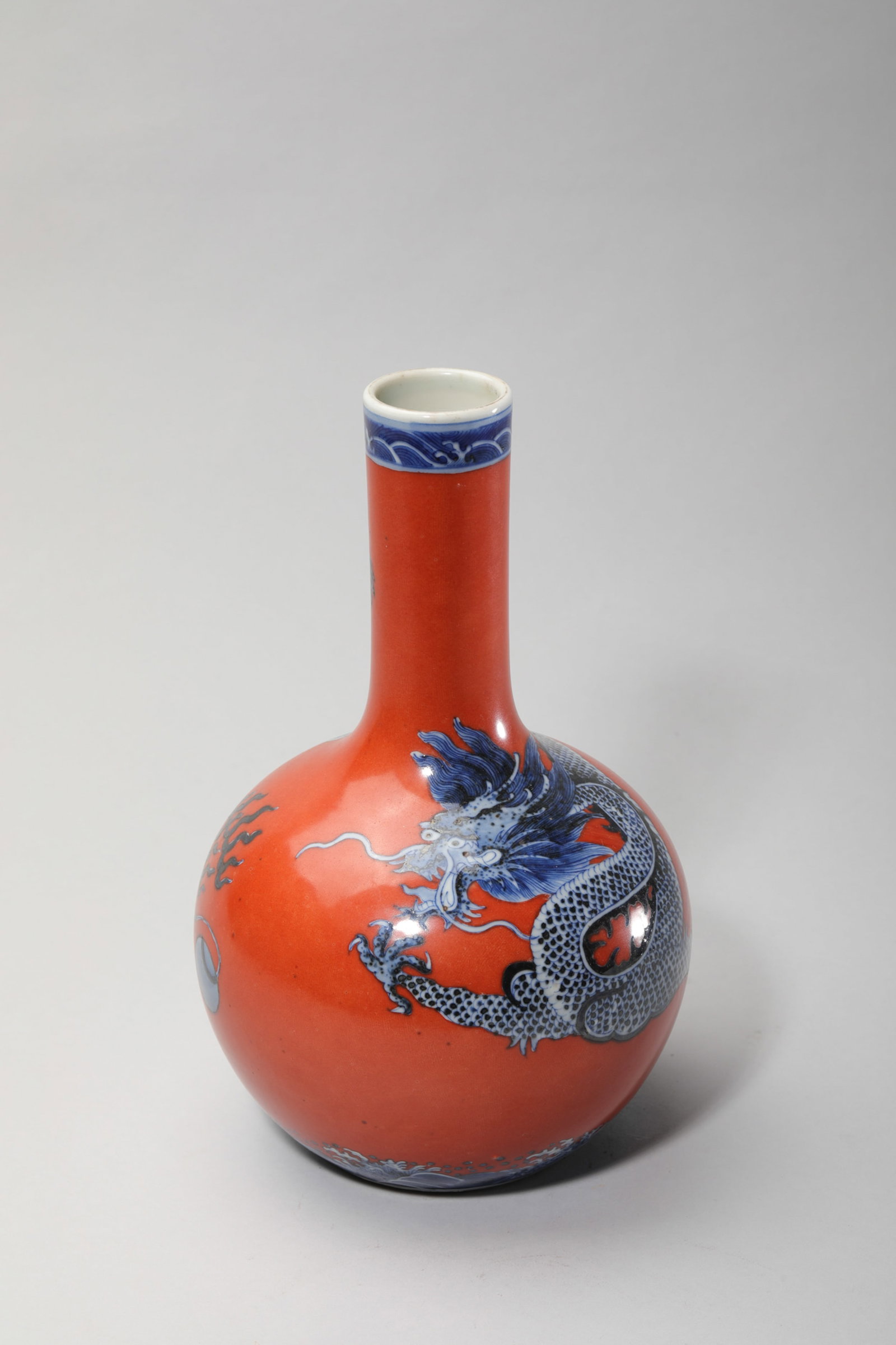A CORAL-RED-GROUND AND UNDERGLAZE-BLUE 'DRAGON' TIANQIUPING (1 of 6)