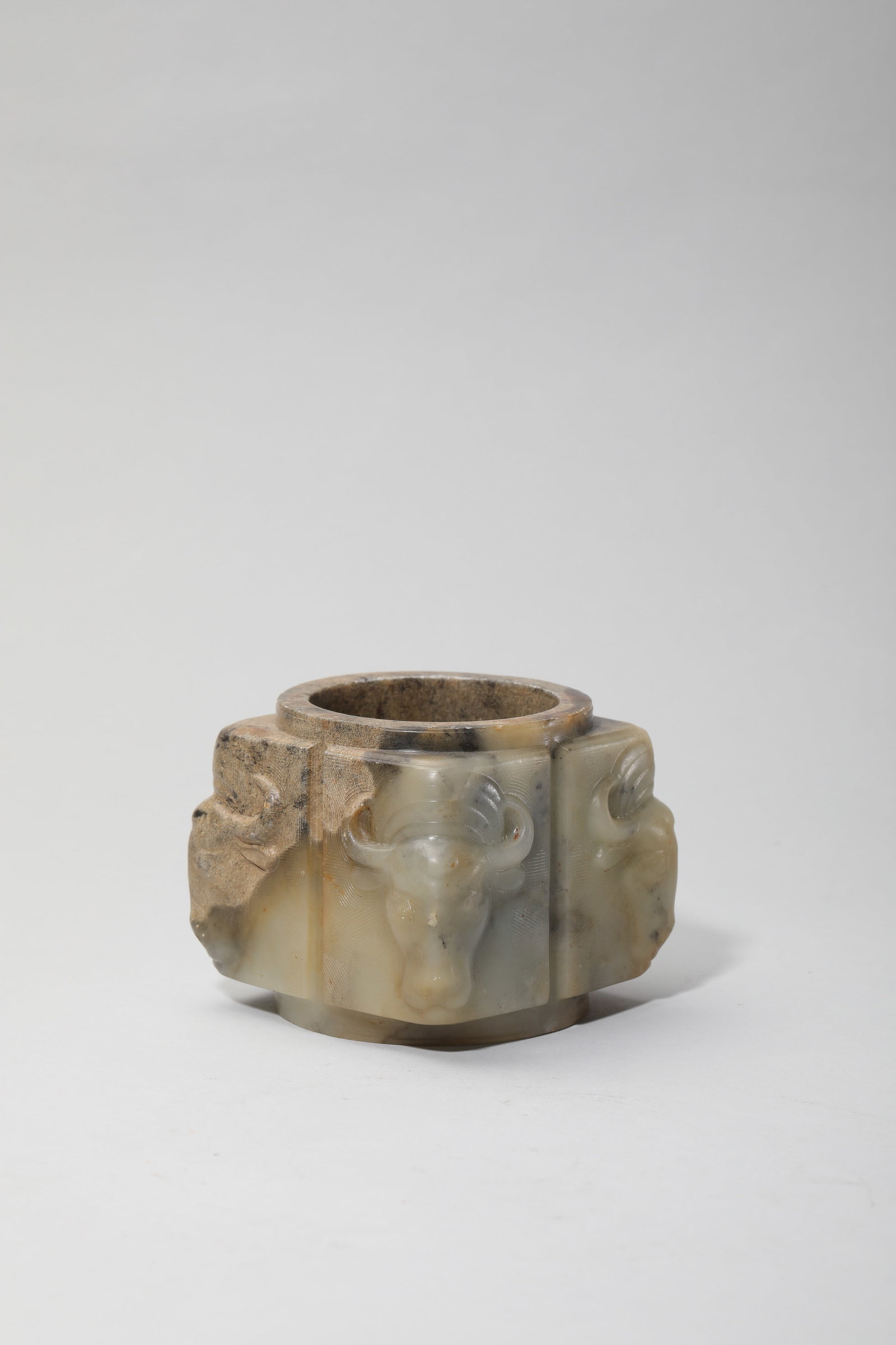 A CHICKEN-BONE-WHITE JADE 'OX' CONG (1 of 5)