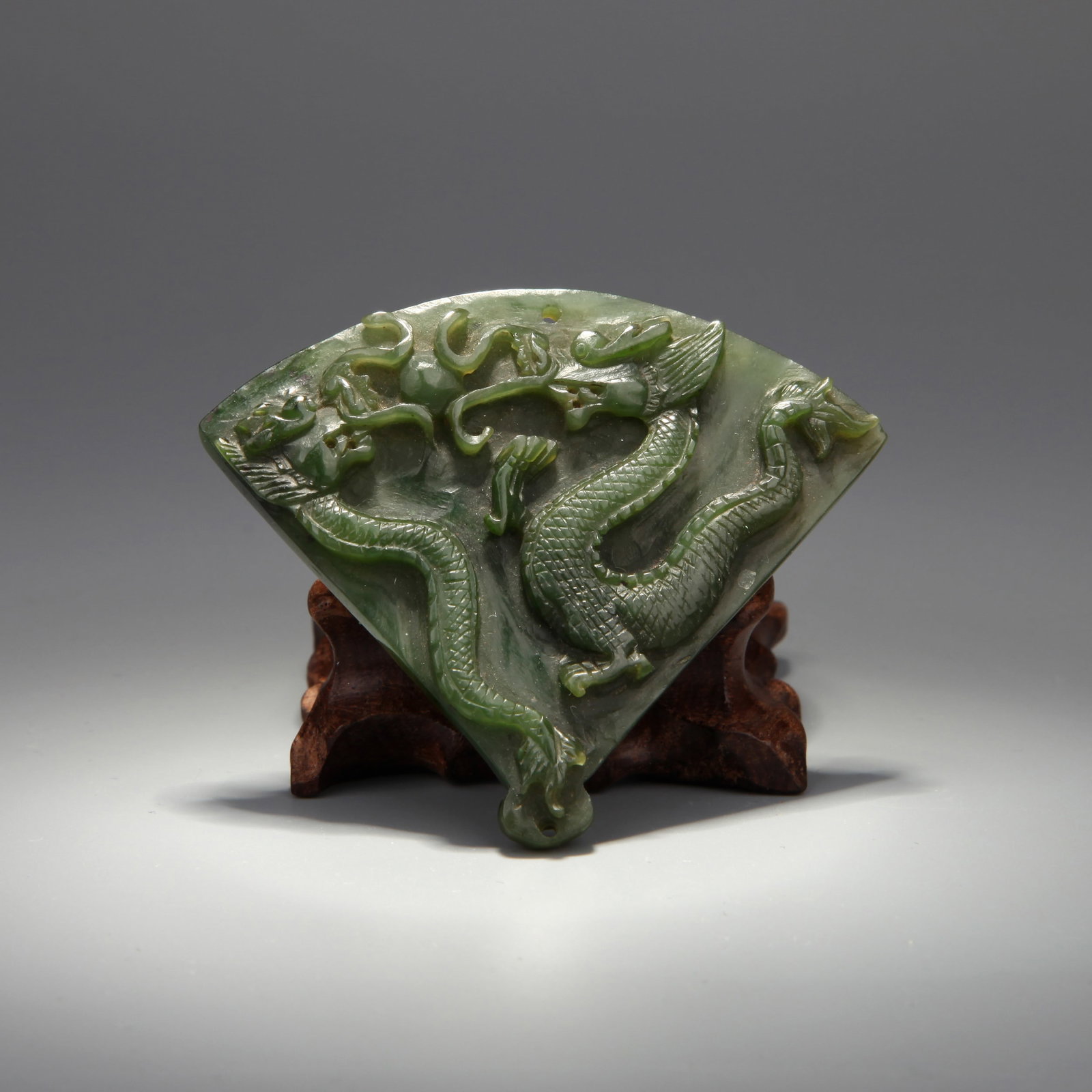 A SPINACH JADE 'DRAGON' FAN-SHAPED PENDANT (1 of 6)