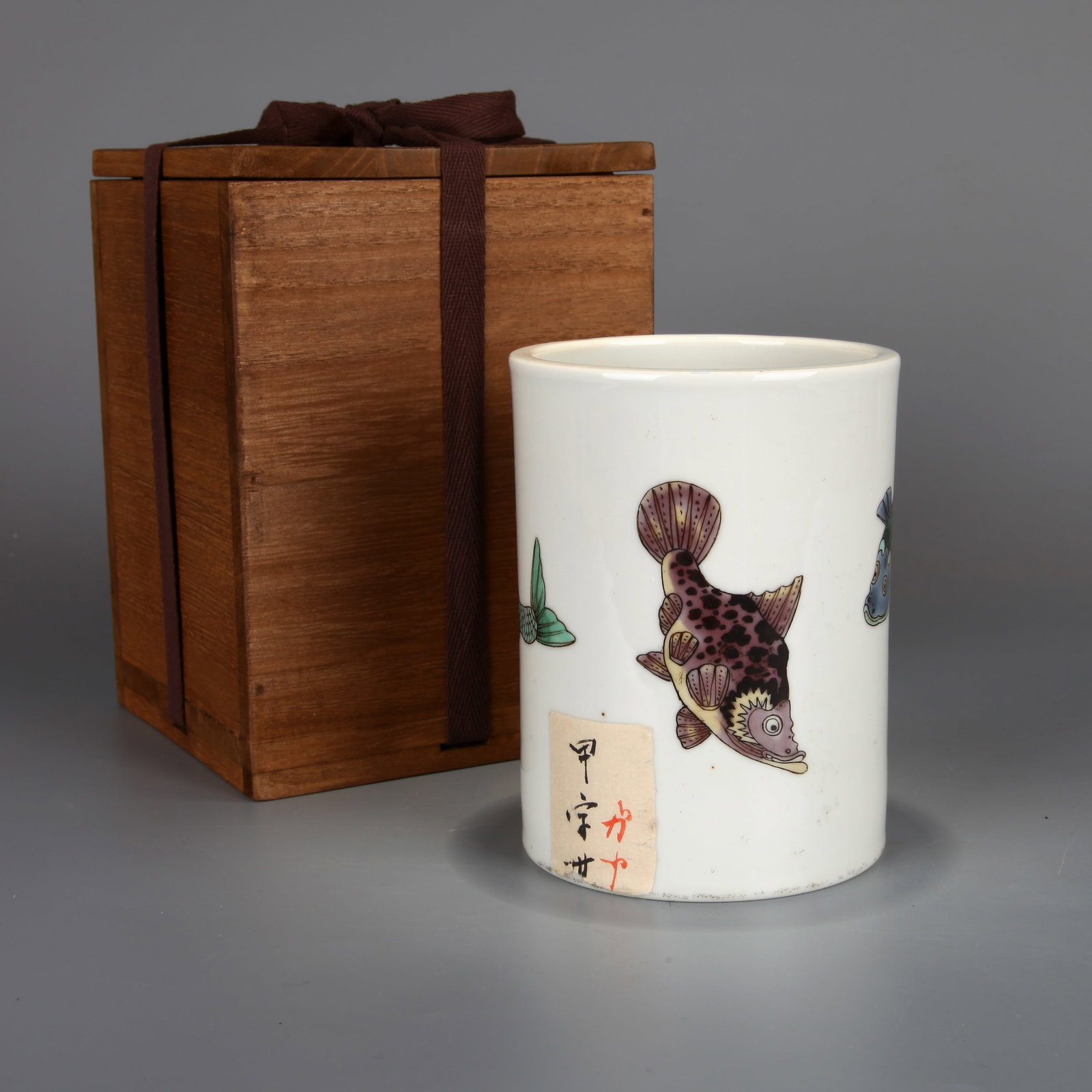 A WUCAI 'FISH' BRUSH POT: A wucai brush pot decorated with fish. With a wooden box.