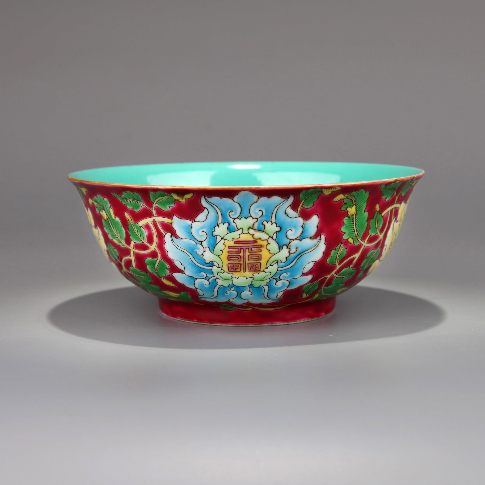 A RUBY-RED-GROUND YANGCAI 'FU' BOWL: A ruby-red-ground Yangcai bowl decorated with floral design and a 'Fu' character.