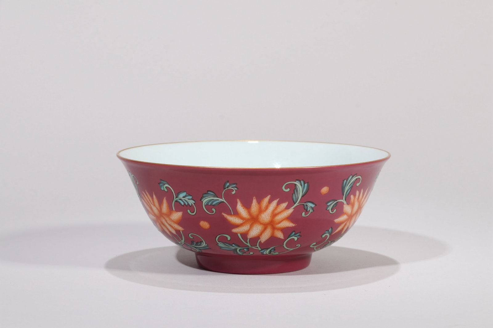 A RUBY-RED-GROUND FAMILLE ROSE 'FLORAL SCROLL' BOWL (1 of 5)