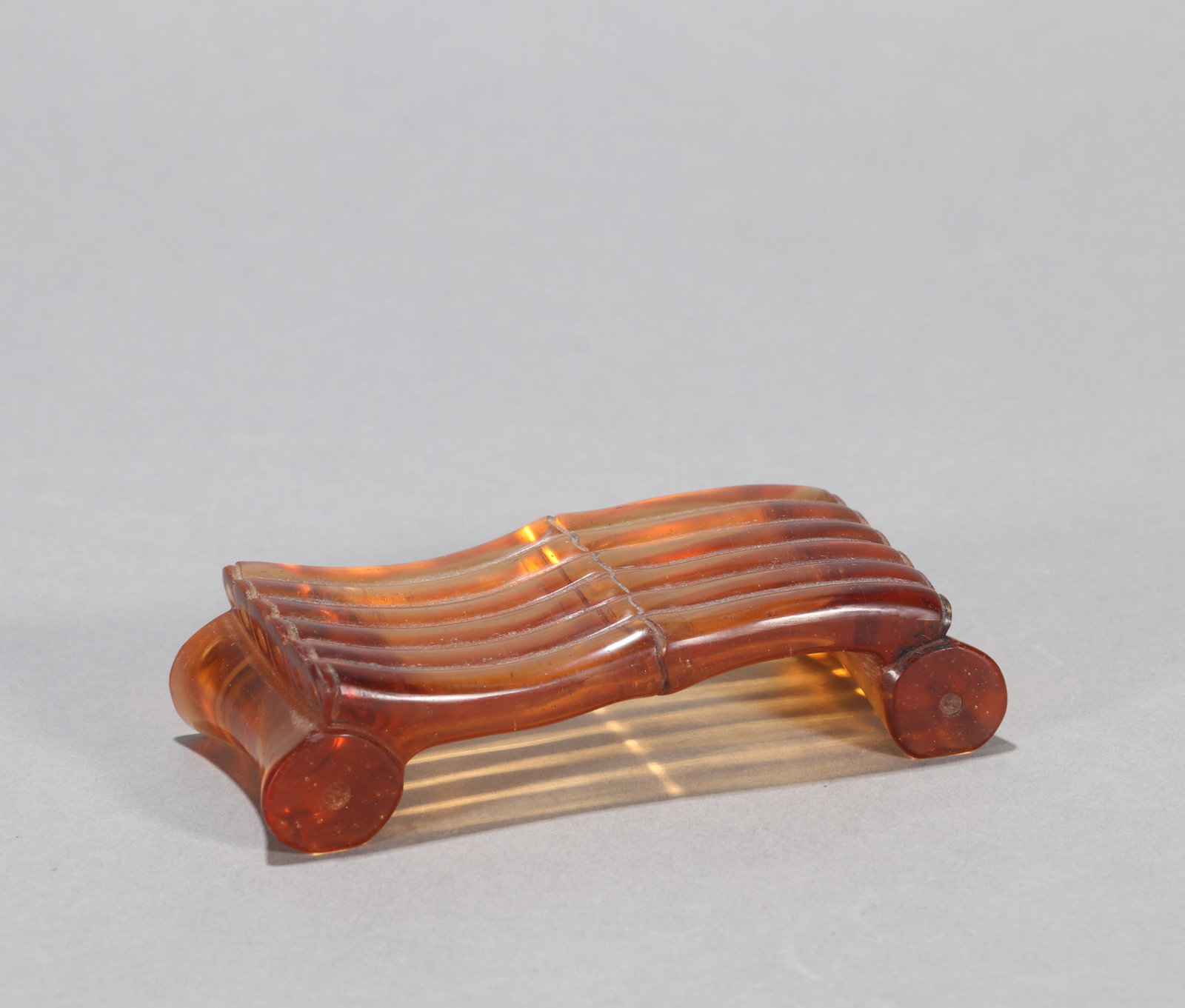 A GLASS BAMBOO-FORM INKSTICK REST: A glass bamboo-form inkstick rest. Length 10 cm.
