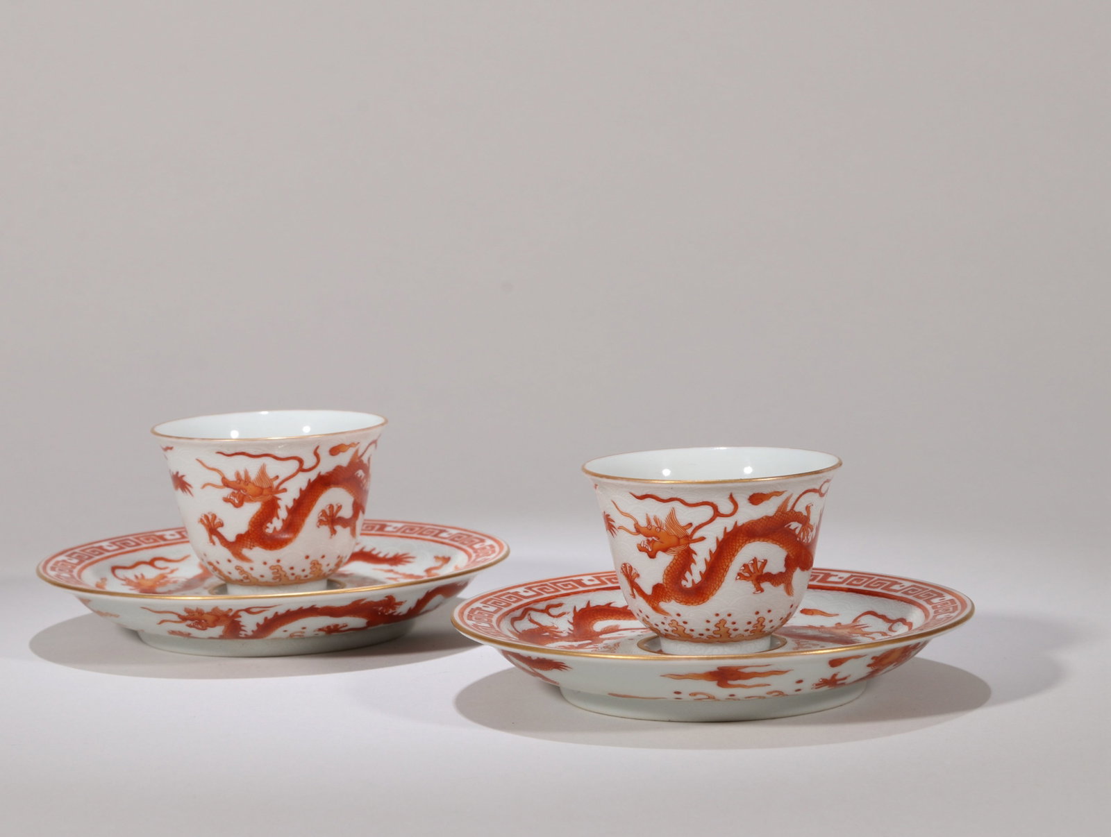 A SET OF TWO IRON-RED 'DRAGON' CUPS AND SAUCERS (1 of 8)