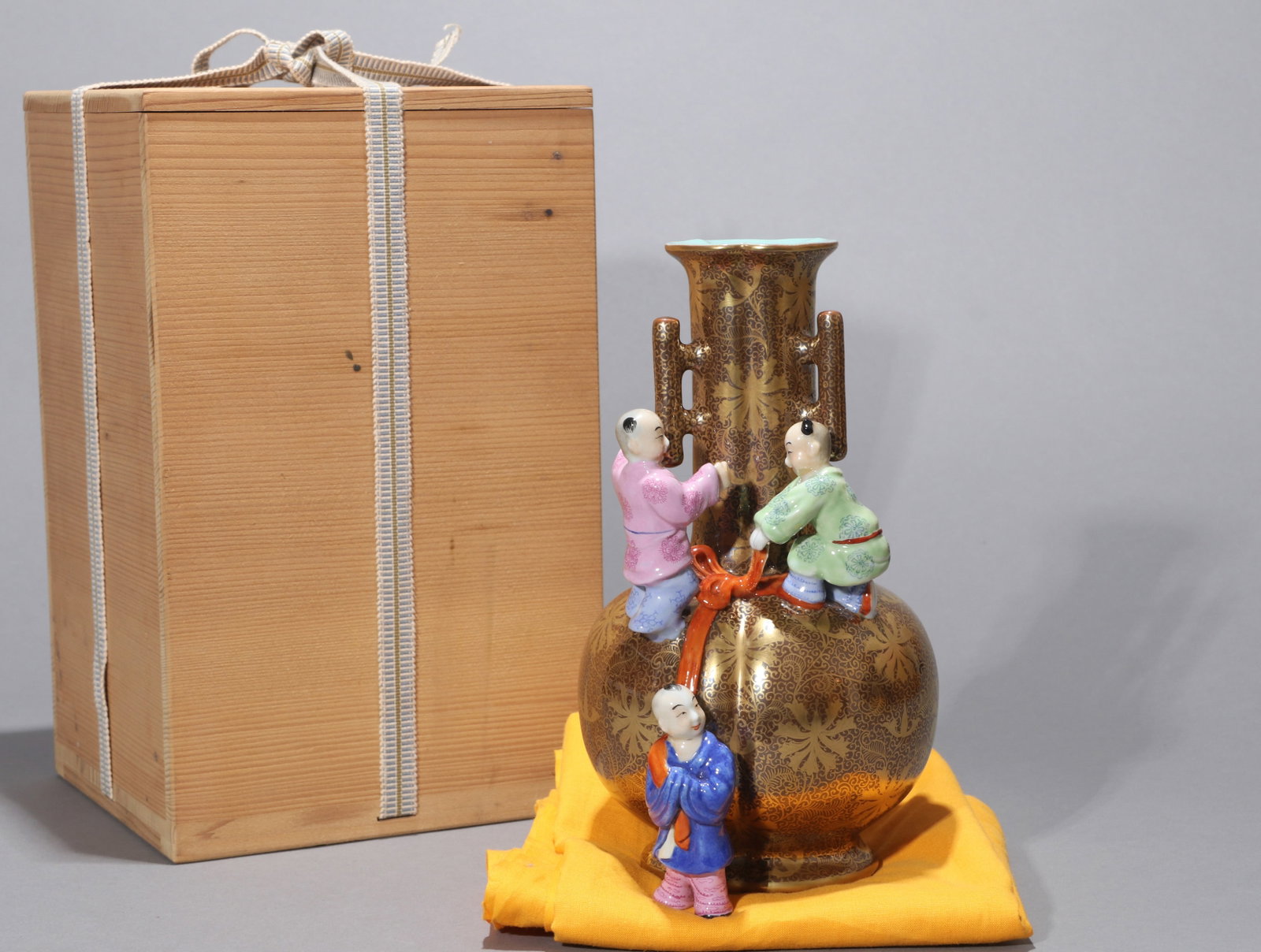 A PURPLE-BROWN-GLAZED AND GILT-DECORATED MOLDED 'BOYS AND LONGEVITY' VASE (1 of 9)