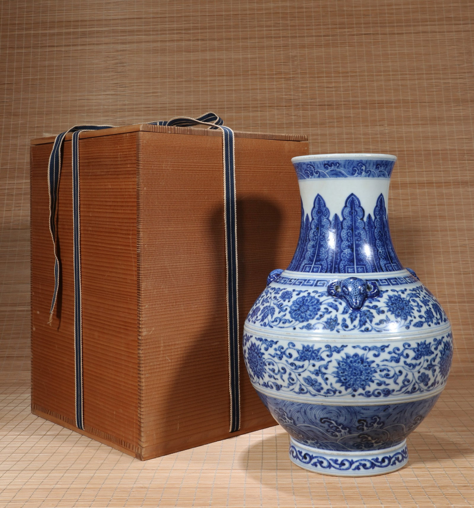 A BLUE AND WHITE 'FLORAL SCROLL AND THREE RAMS' ZUN-FORM VASE: A blue and white 'floral scroll and three rams' zun-form vase. Height 32 cm.