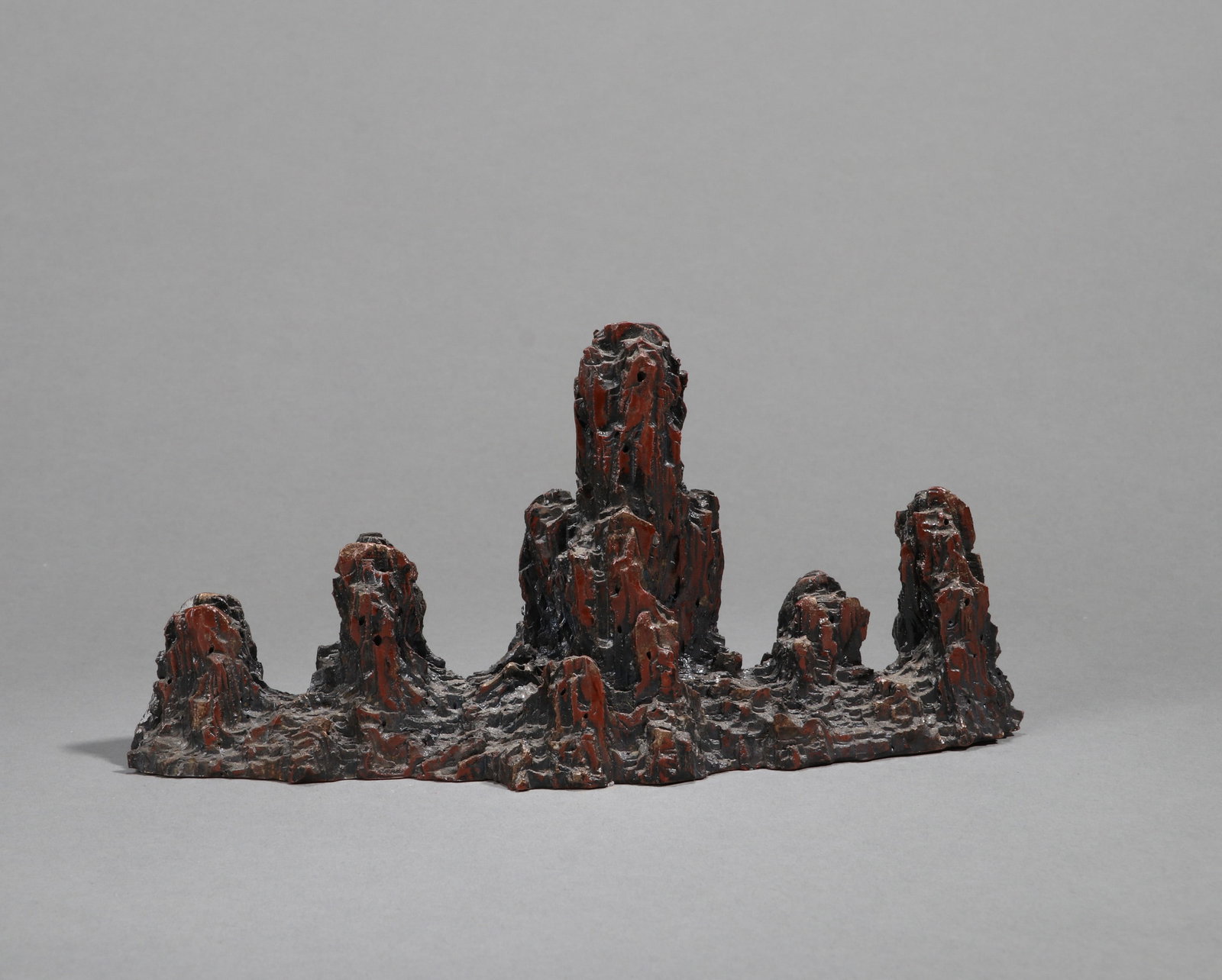 A PORCELAIN LINGBI-STONE-FORM BRUSH REST (1 of 4)