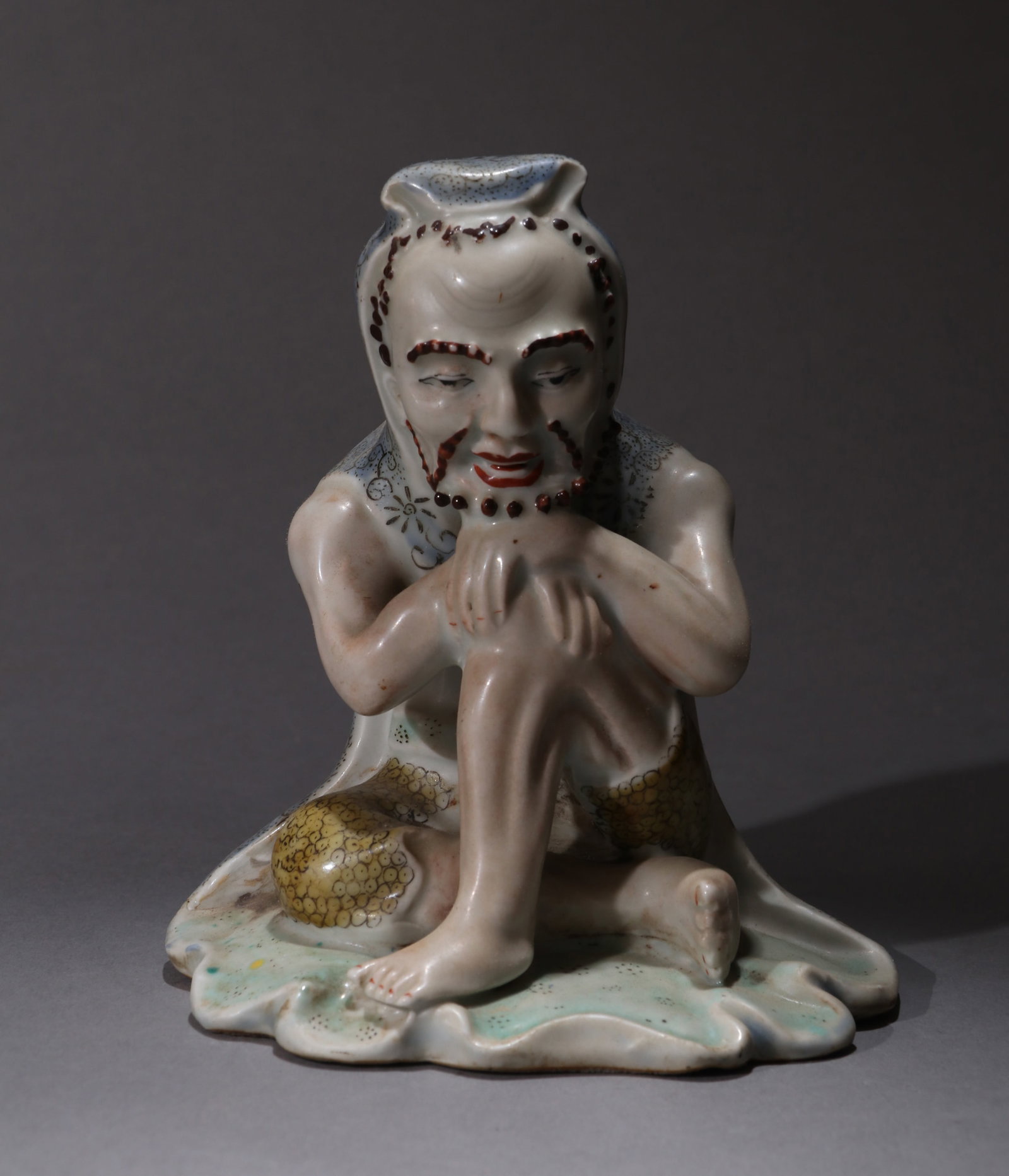A FAMILLE-ROSE EMACIATED LUOHAN FIGURE (1 of 6)