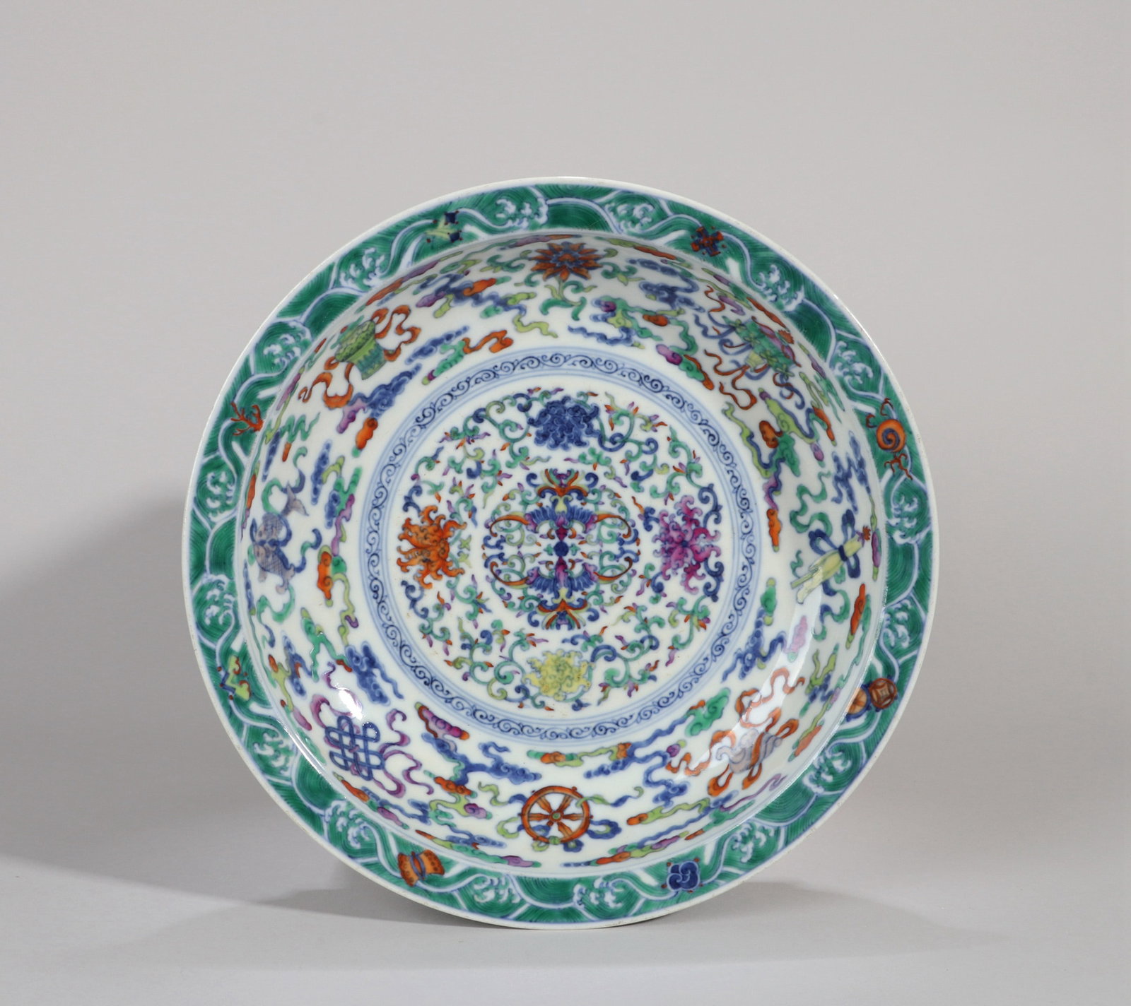 A DOUCAI DISH WITH FLORAL SCROLLS AND THE EIGHT BUDDHIST EMBLEMS
