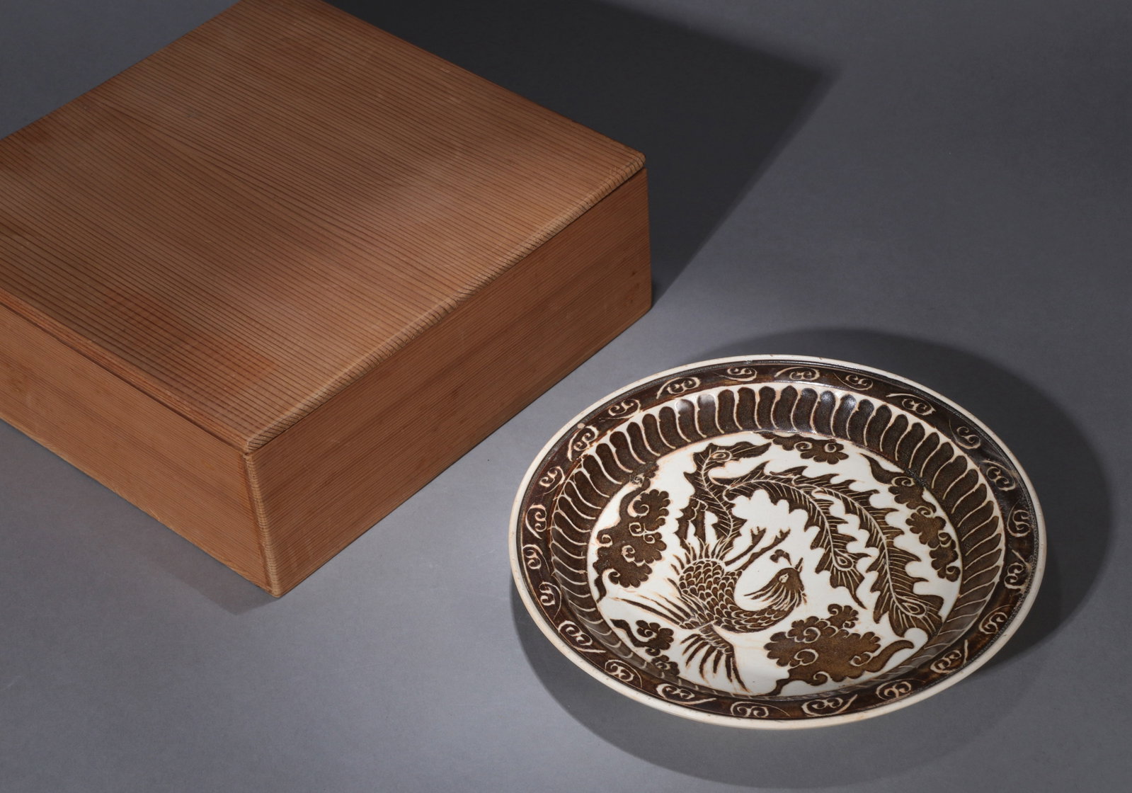A DING-TYPE CARVED 'PHOENIX' DISH