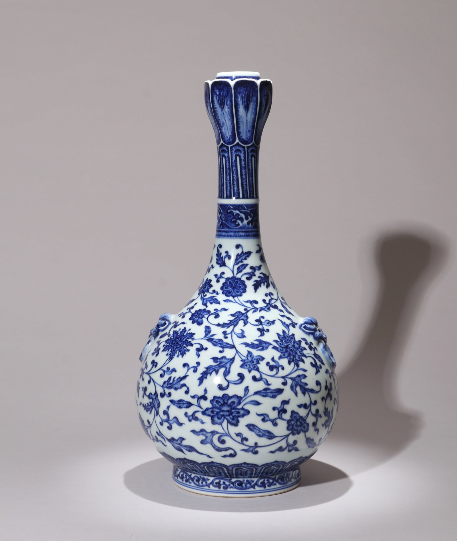 A BLUE-AND-WHITE GARLIC-MOUTH VASE WITH FLORAL SCROLLS AND MASK HANDLES