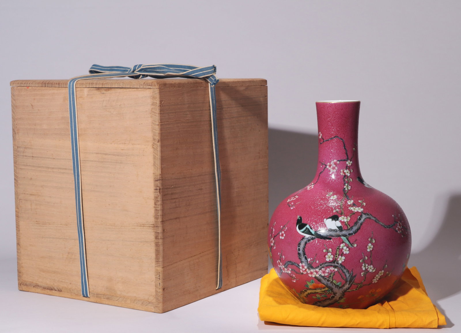 A RUBY-RED SGRAFFITO FAMILLE-ROSE 'MAGPIE AND PLUM BLOSSOM' TIANQIUPING VASE
