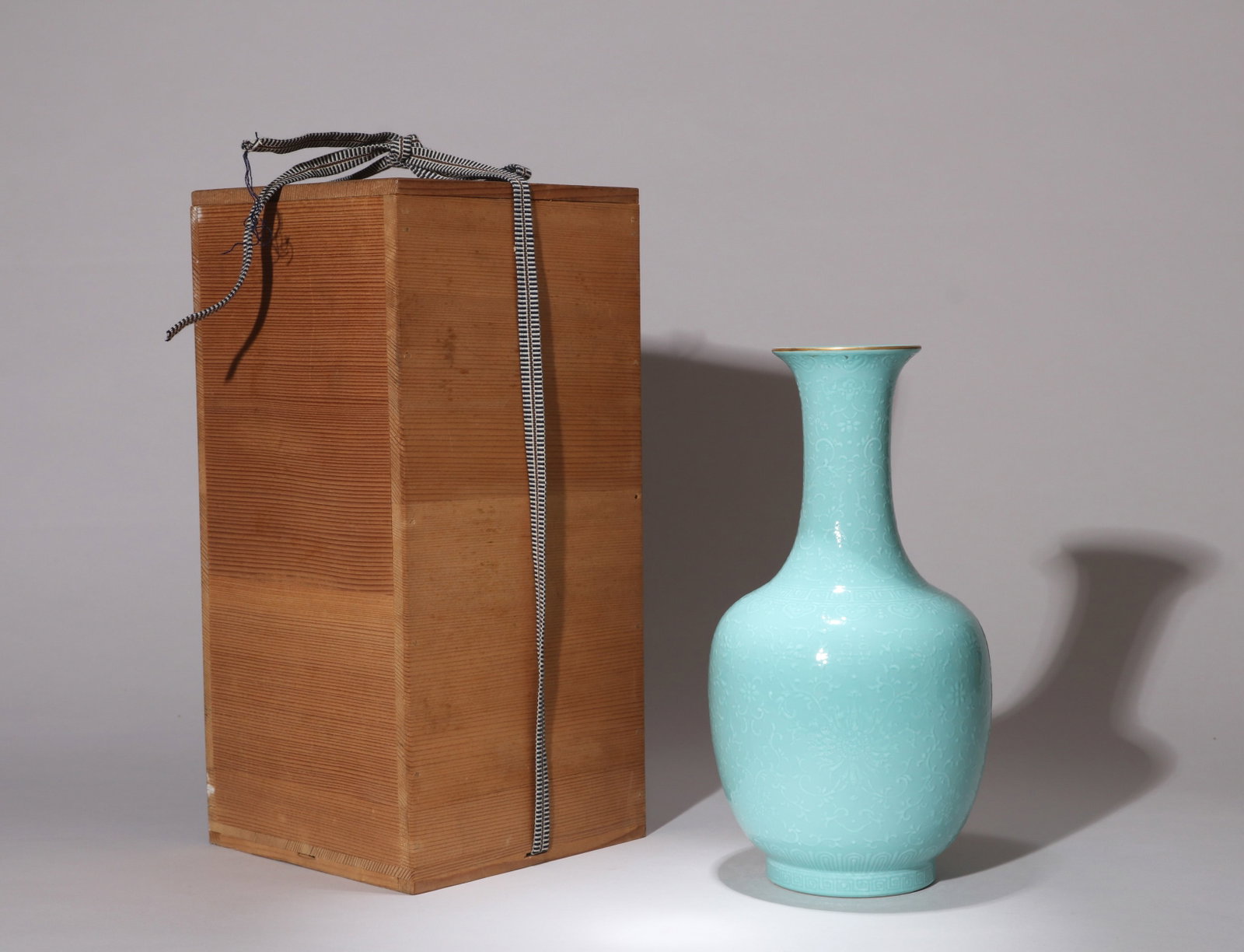A TURQUOISE-GLAZED VASE WITH APPLIED WHITE LOTUS SCROLLS AND DOUBLE-HAPPINESS CHARACTERS: A turquoise-glazed vase with applied white lotus scrolls and double-happiness characters. Height 24 cm.