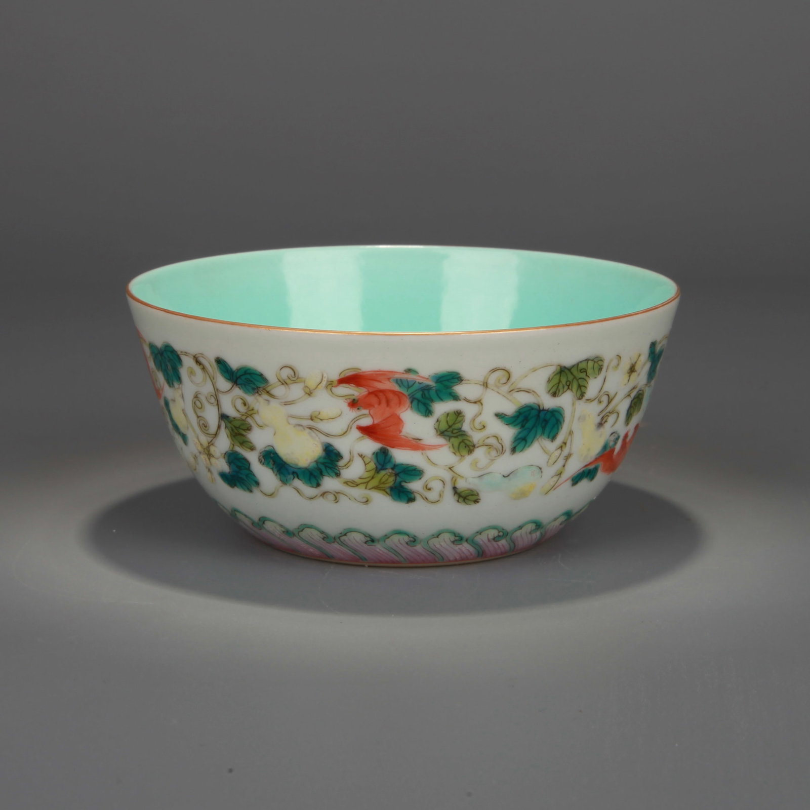 A FAMILLE-ROSE BOWL WITH GOURDS, VINES AND BATS: A famille-rose bowl with gourds, vines and bats. Height 4.2 cm, diameter 9.1 cm.