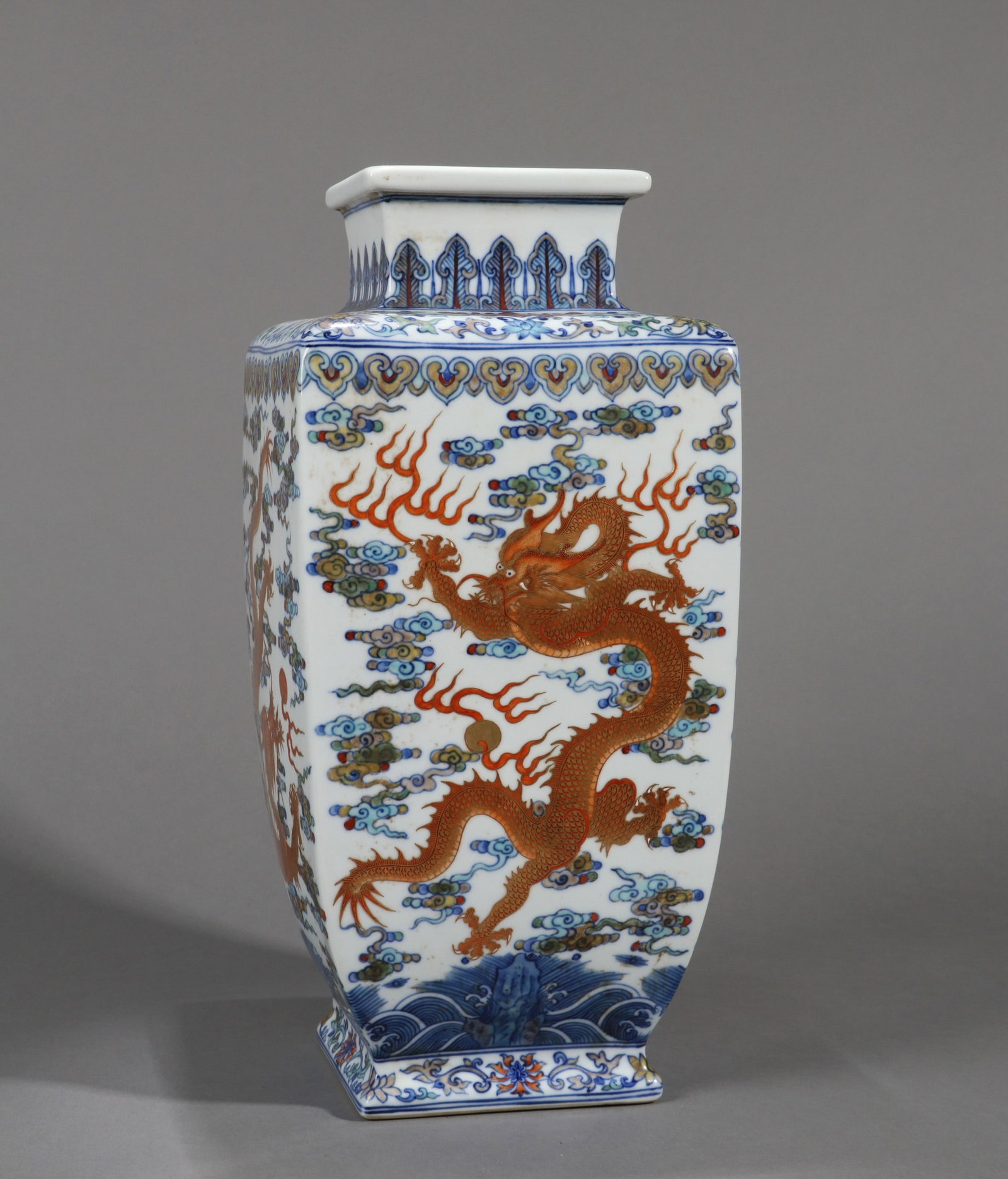 A GILT-DECORATED DOUCAI 'DRAGON' SQUARE VASE: A gilt-decorated doucai square vase decorated with a cloud-and-dragon design. Height 39 cm.