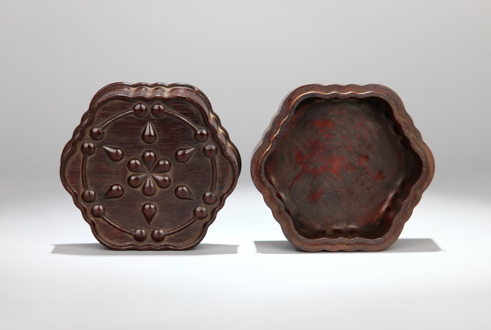 A HUANGHUALI 'FLORAL' INCENSE BOX: A huanghuali incense box with floral design. Height 6.5 cm, diameter 9.3 cm.