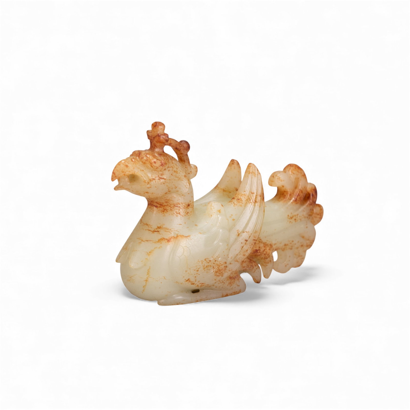 CHINESE JADE CARVING OF A PHOENIX, PROBABLY HAN DYNASTY: Chinese jade carving of a phoenix, probably Han dynasty. 2.56"h x 3.94"w x 1.18"l (6.5 x 10 x 3 cm) Provenance: From an estate in Rancho Palos Verdes, California.