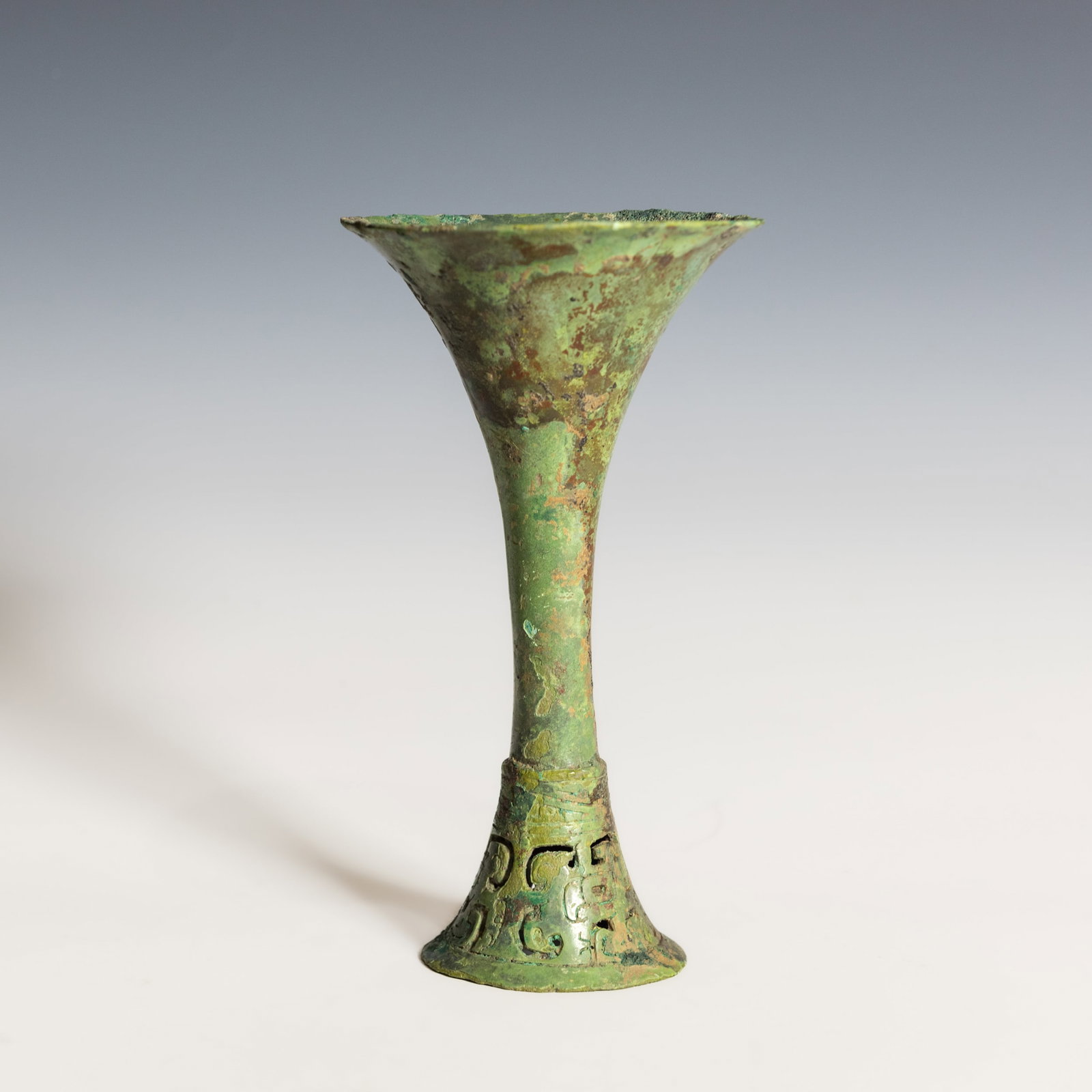EARLY CHINESE RITUAL BRONZE WINE VESSEL (GU), PROBABLY SHANG DYNASTY: Early Chinese ritual bronze wine vessel (gu), probably Shang dynasty. 7.28"h x 4.13"d (18.5 x 10.5 cm) Provenance: Purchased from Tsu Po Antique Co., Hong Kong, on July 24, 1968, by repute.