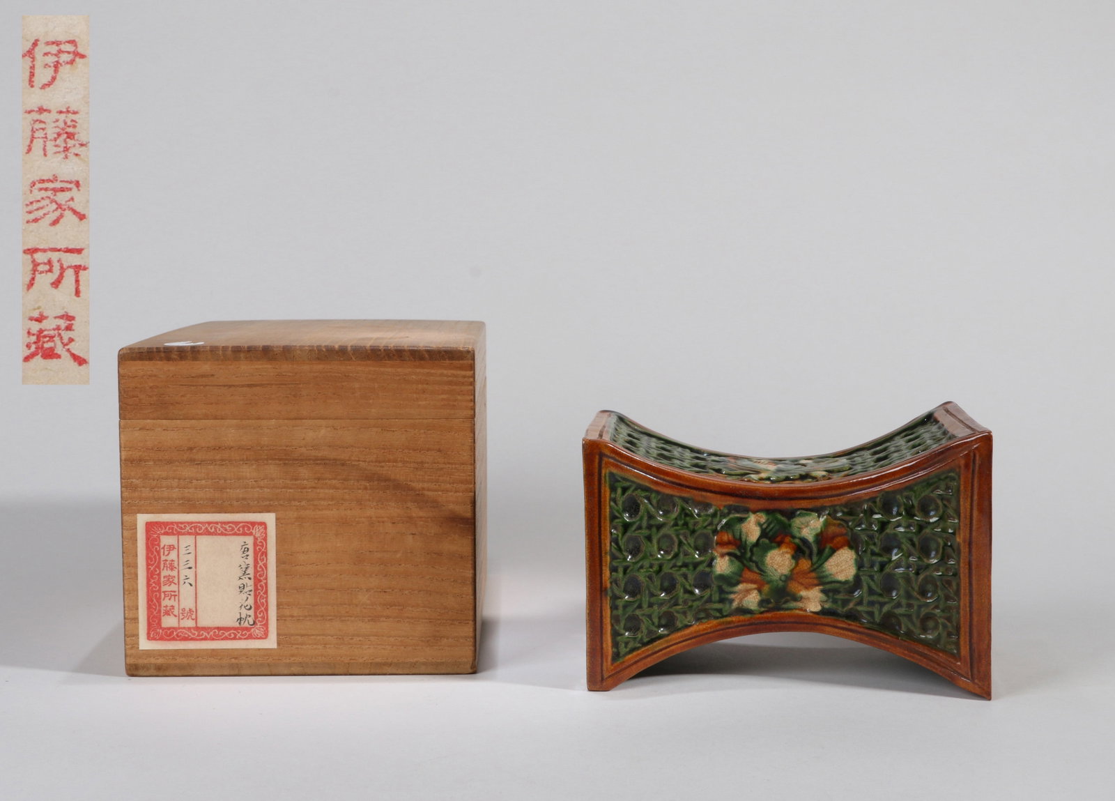 A SANCAI-GLAZED WAISTED PILLOW: A sancai-glazed waisted pillow. 10.5 x 10.5 x 15.5 cm. Note: By repute, from the Ito family collection.