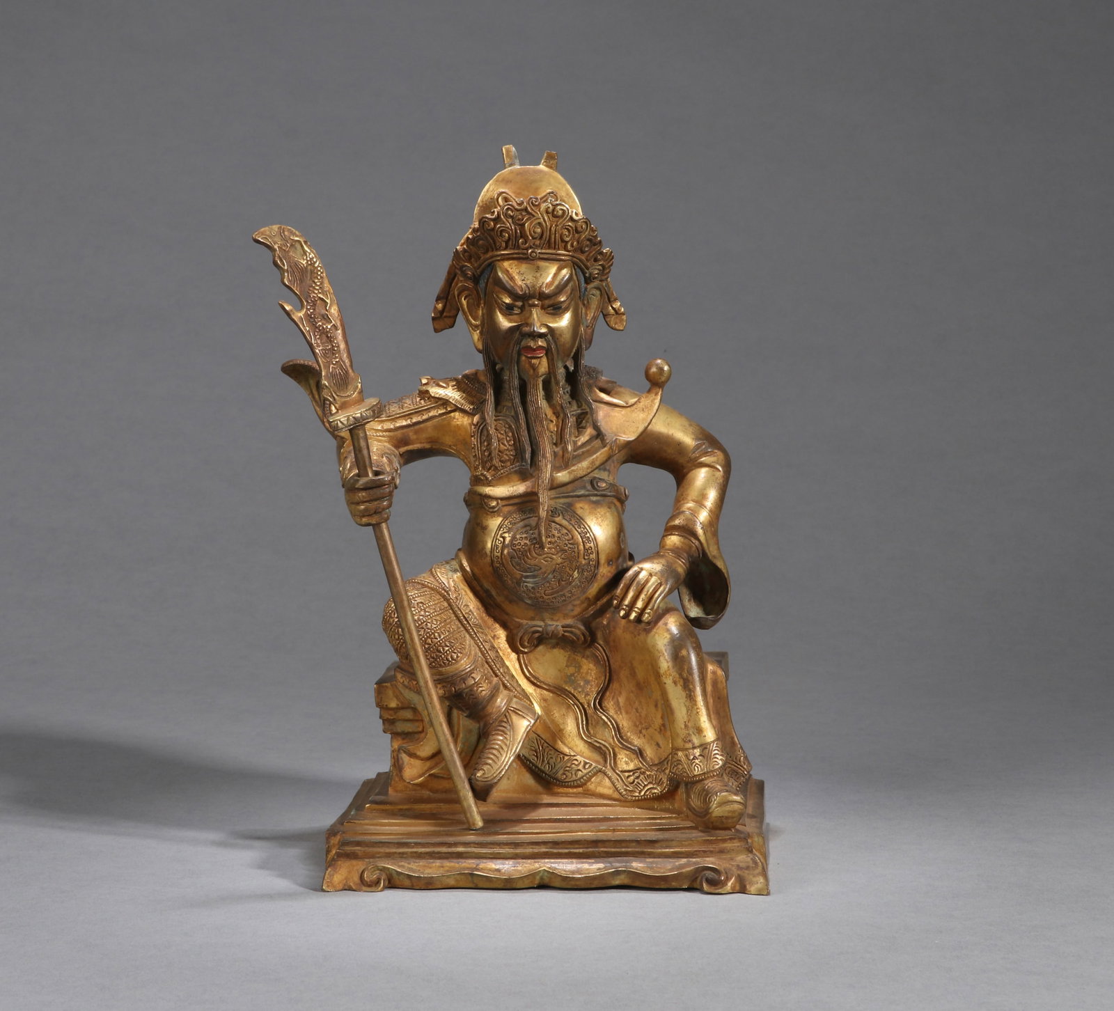 A GILT-BRONZE FIGURE OF GUAN GONG: A gilt-bronze figure of Guan Gong. Height 23 cm.