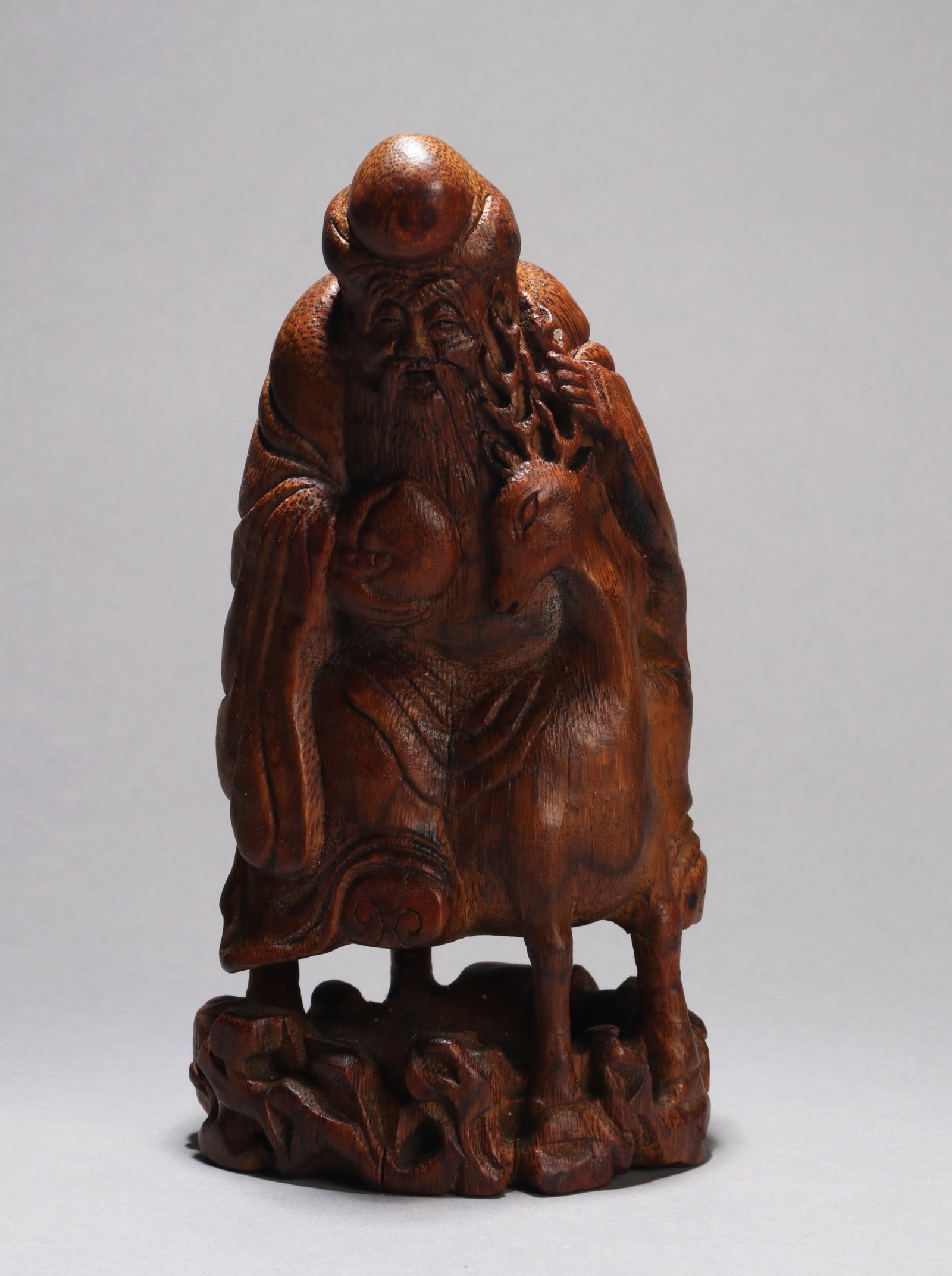 A BAMBOO-CARVED FIGURE OF SHOULAO: A bamboo-carved figure of Shoulao. Height 23 cm.