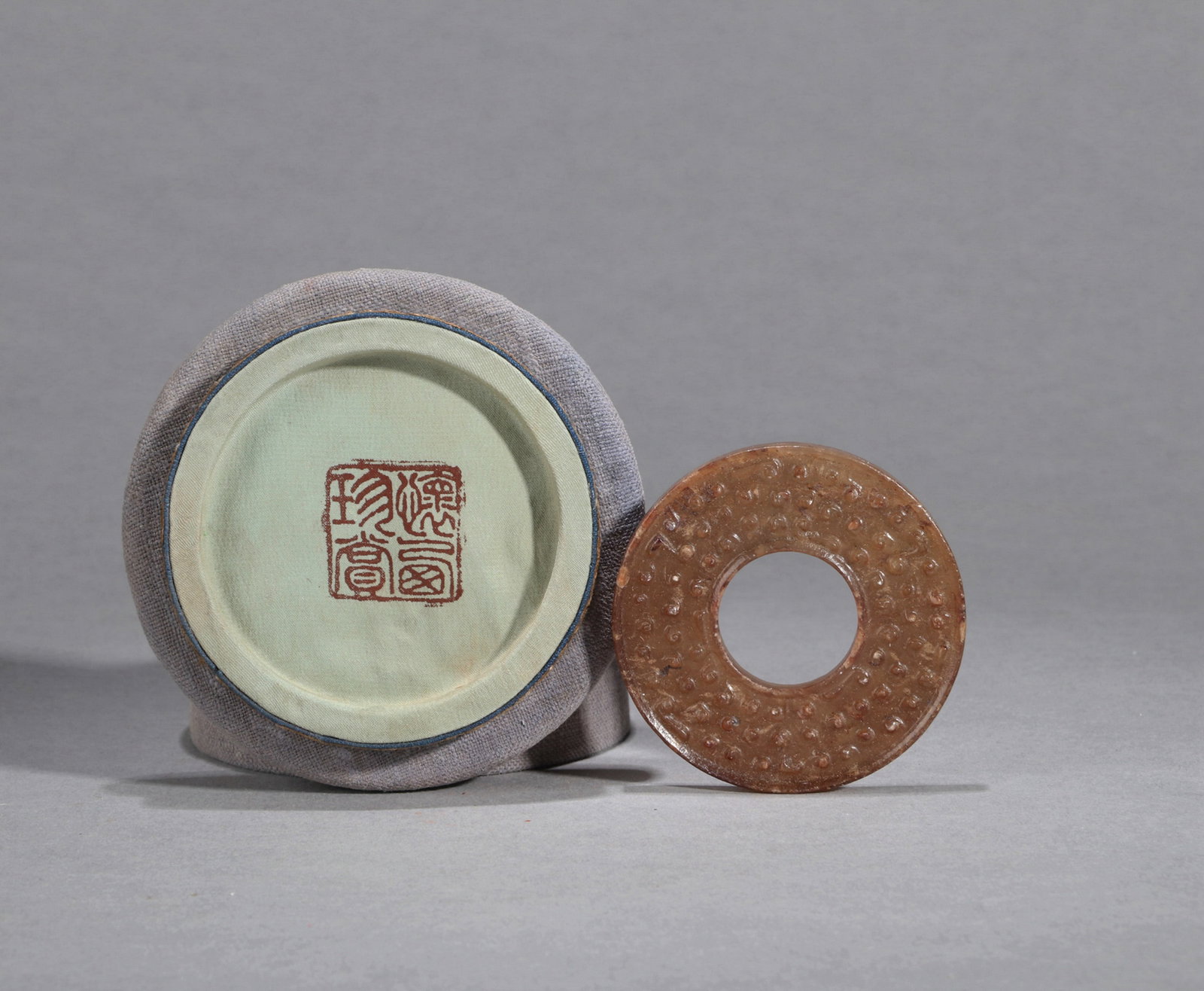 A HETIAN JADE BI DISC WITH RAISED GRAIN PATTERN (1 of 5)